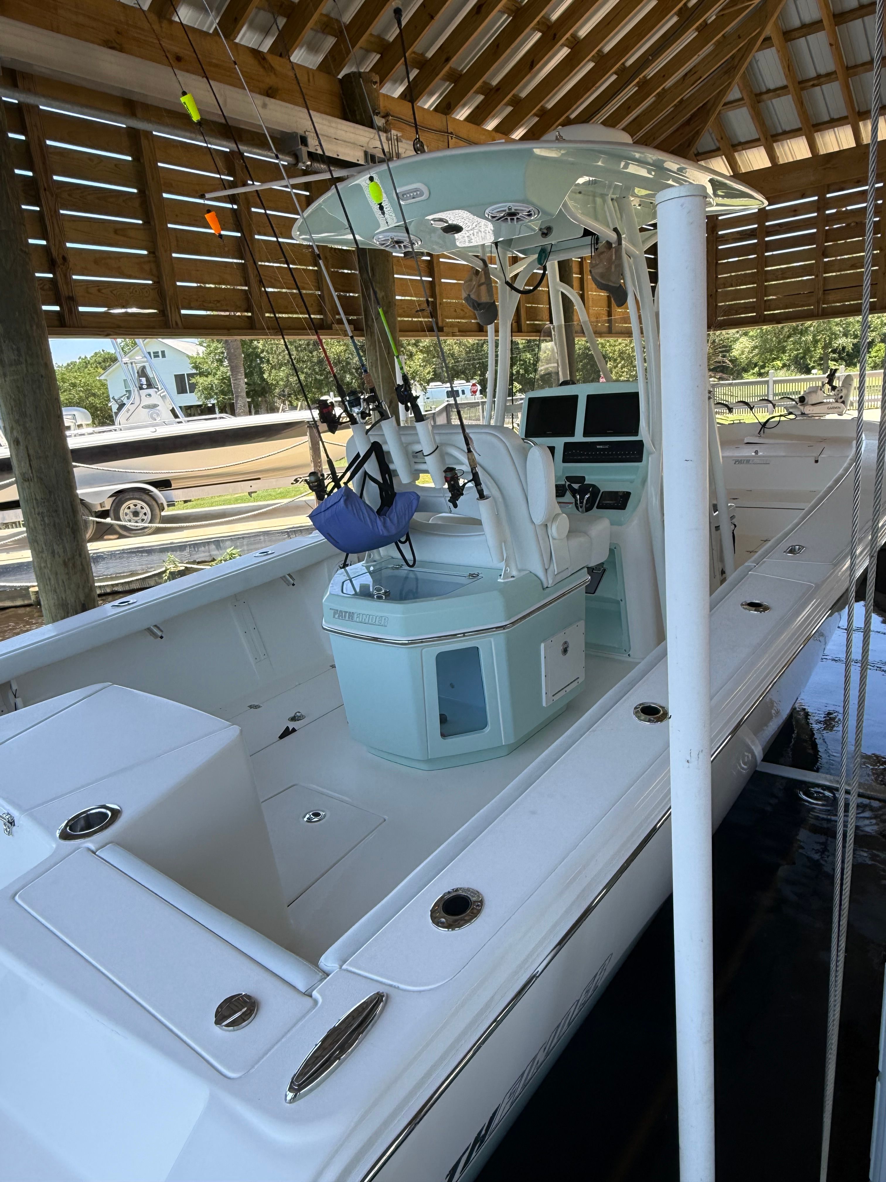 2024 Pathfinder 2700 Open boat under a wooden roof.