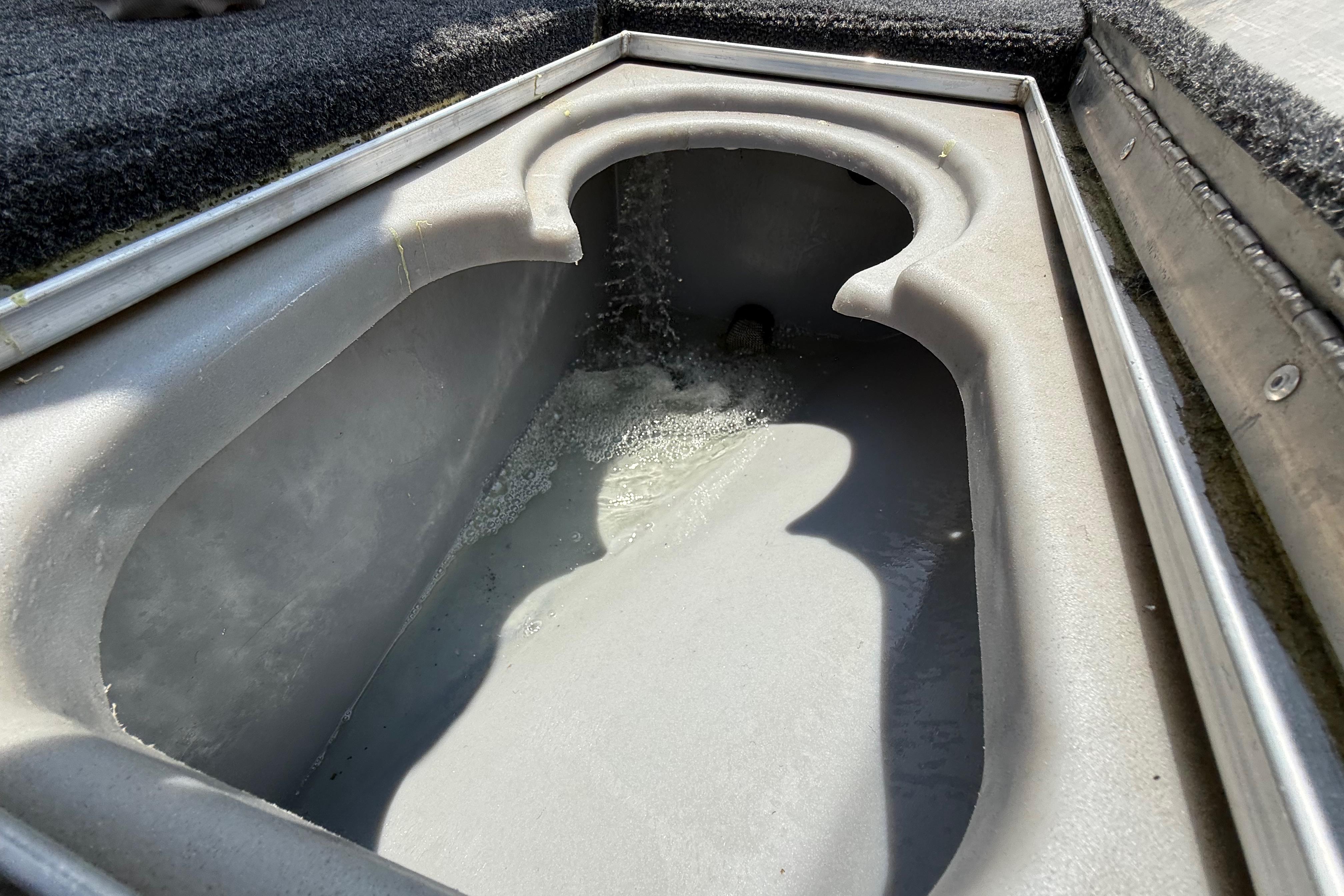 Livewell in 2015 Tracker Pro Team 190 TX boat, partially filled with water.