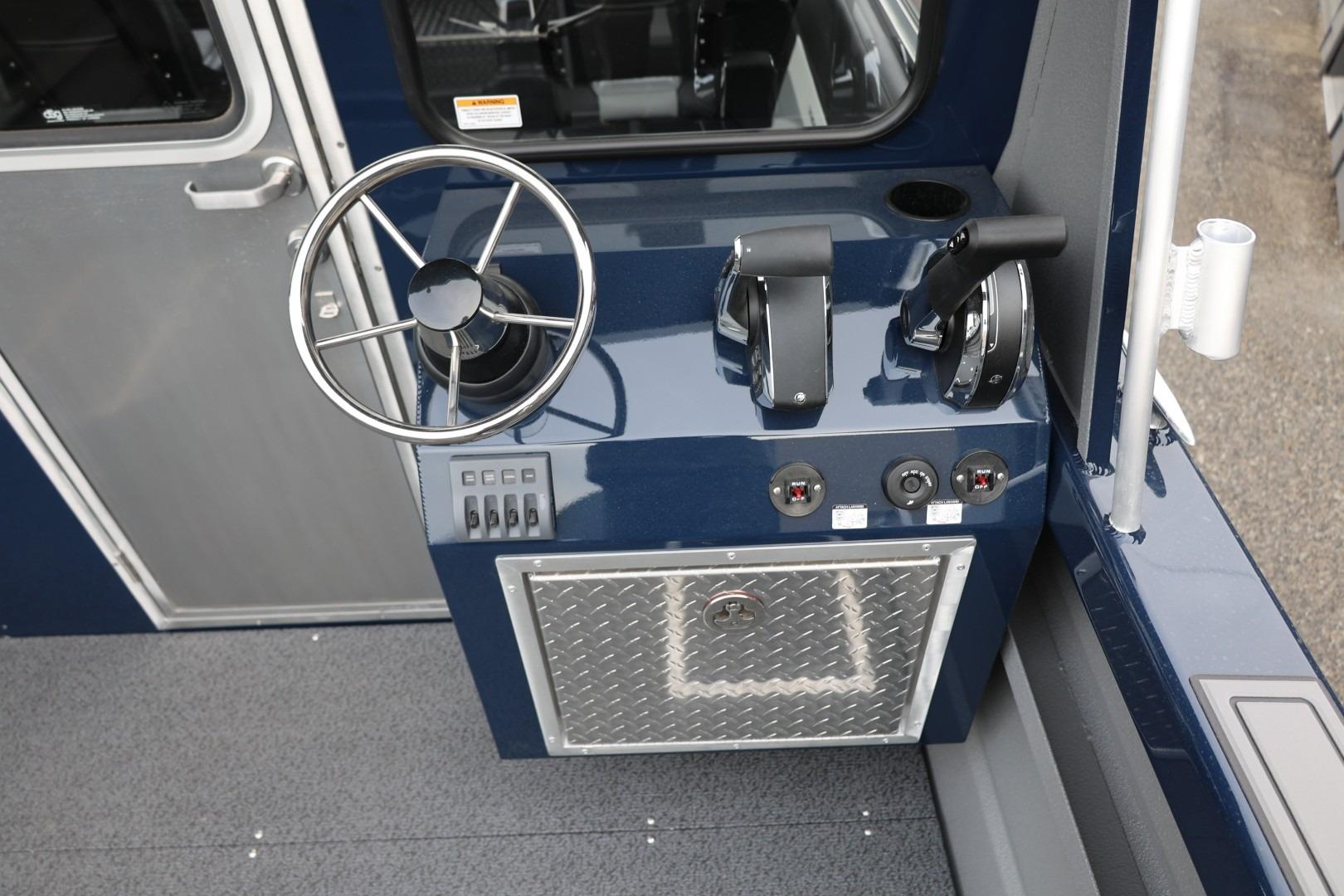 Helm of 2026 Thunder Jet 24 Alexis Pro boat with steering wheel and controls.