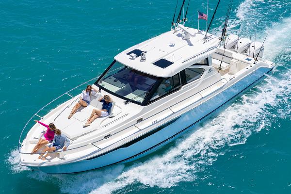 Manufacturer Provided Image: 2025 Pursuit OS 445 Offshore yacht cruising with passengers on turquoise water.