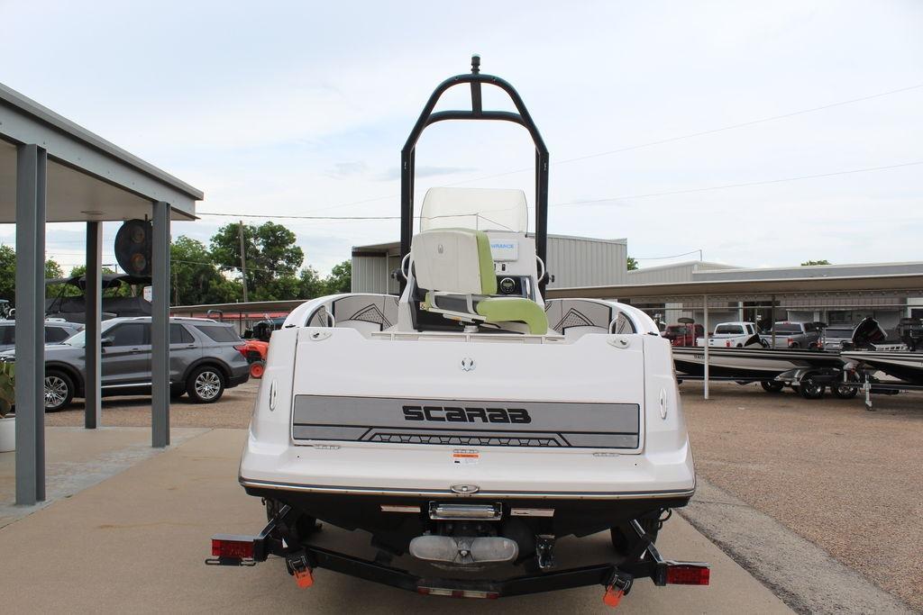 Rear view of a 2017 Scarab 195 boat parked outdoors, showcasing its sleek design.
