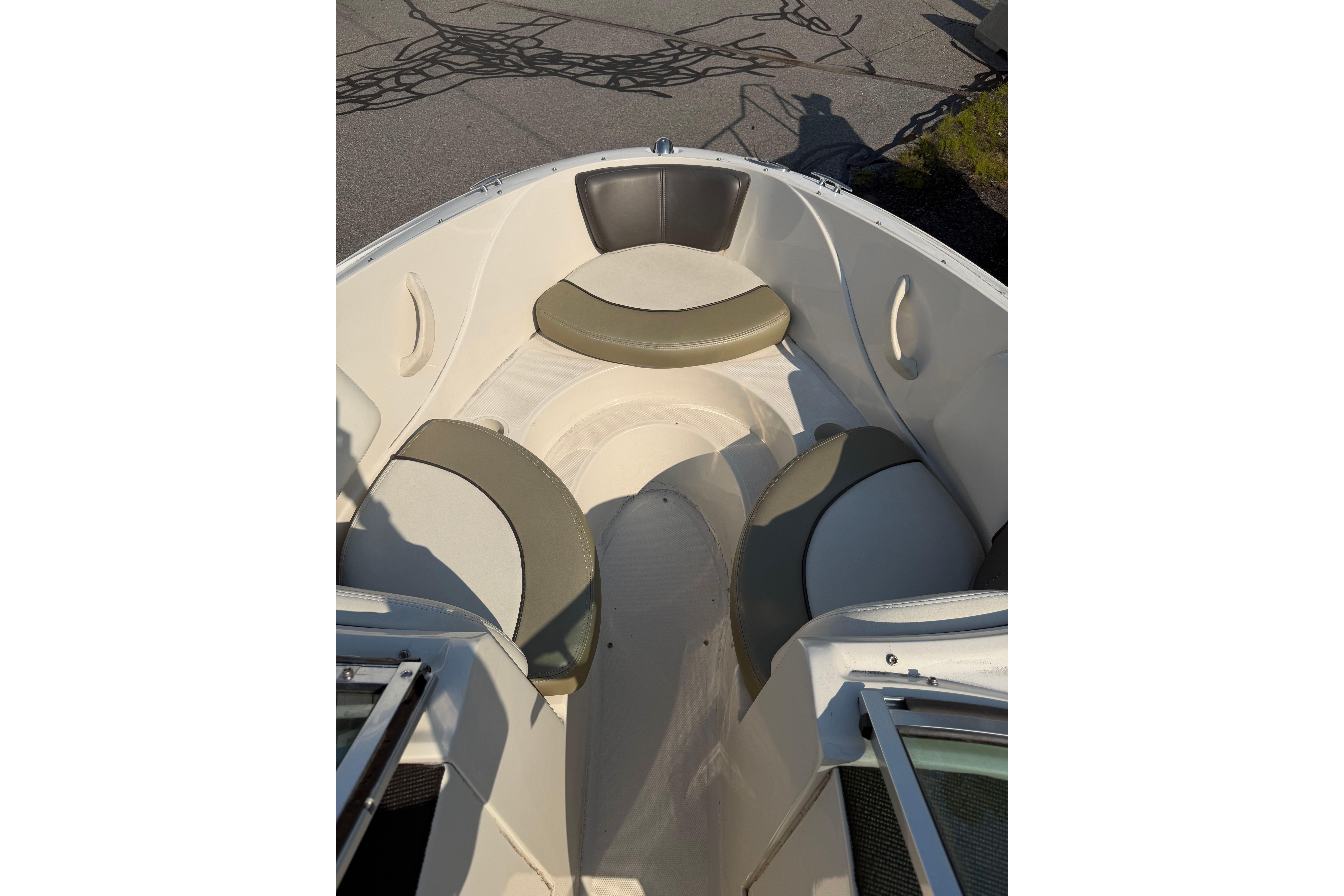 2006 Sea Ray 195 Sport boat interior with cushioned seating in sunlight.