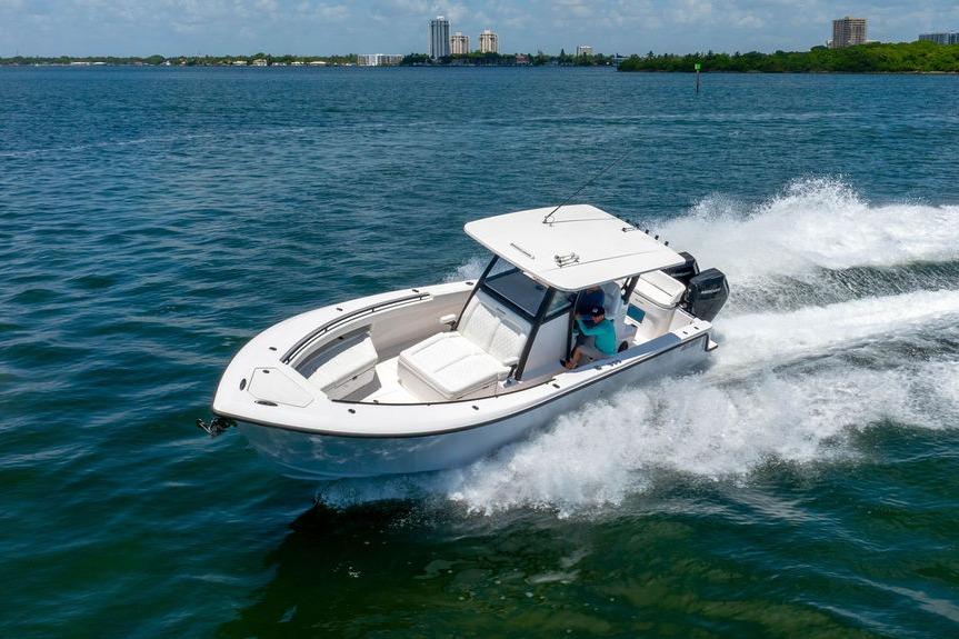 2027 Reef Runner 340 boat cruising on open water, creating a dynamic wake.