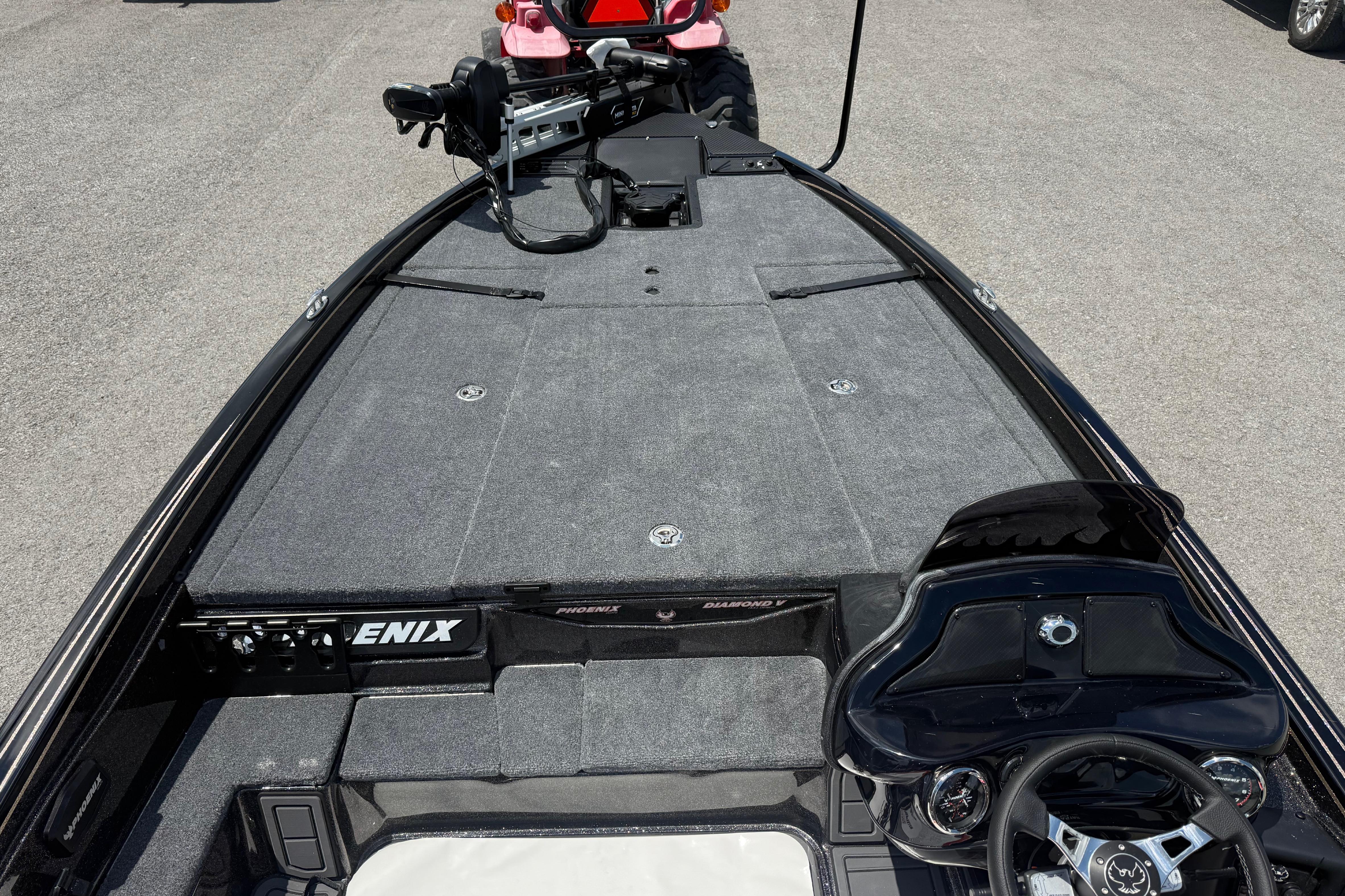 2027 Phoenix 721 ZXL boat interior with steering wheel and carpeted deck.