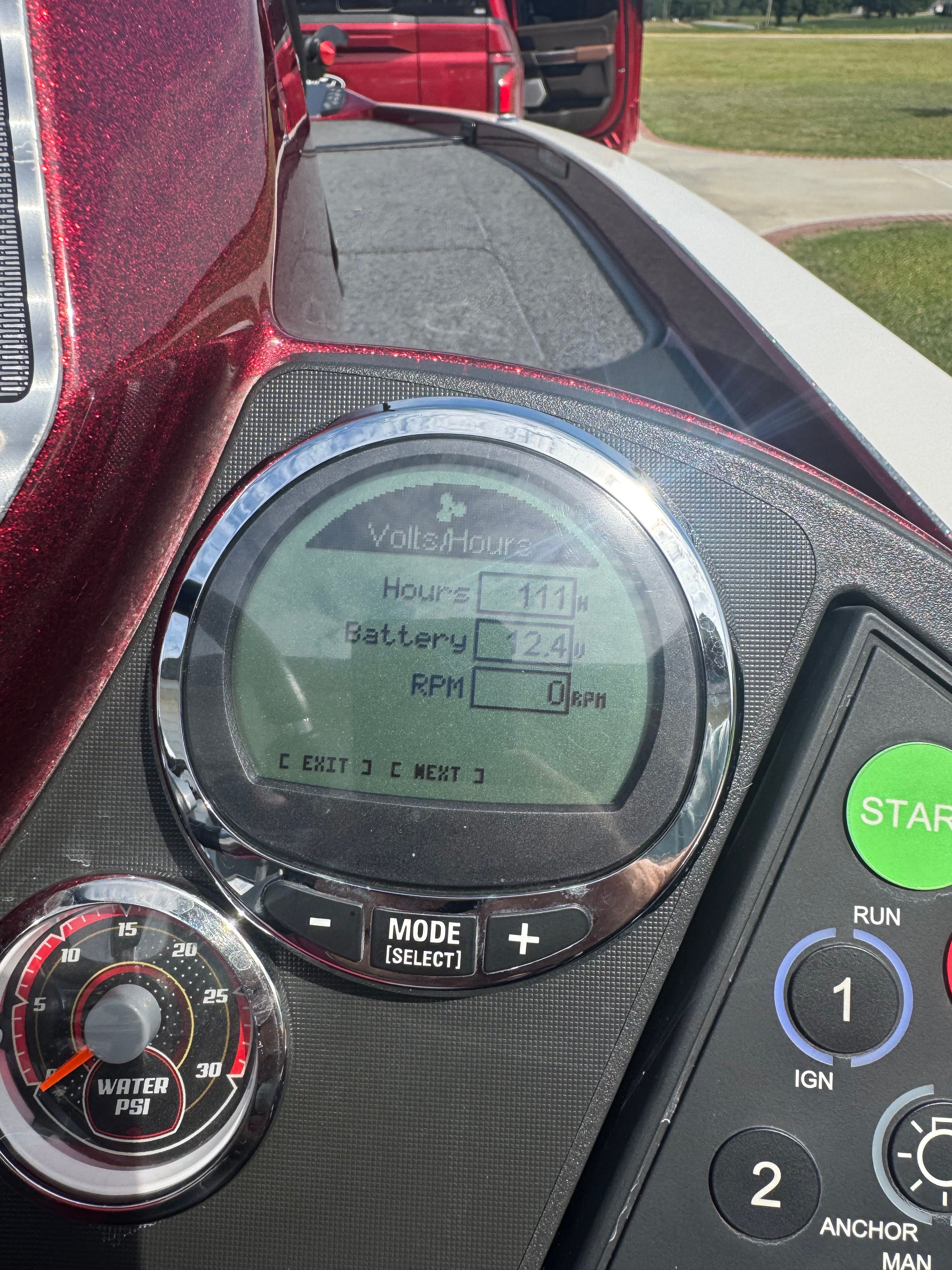 Close-up of a boat dashboard with digital displays and controls.