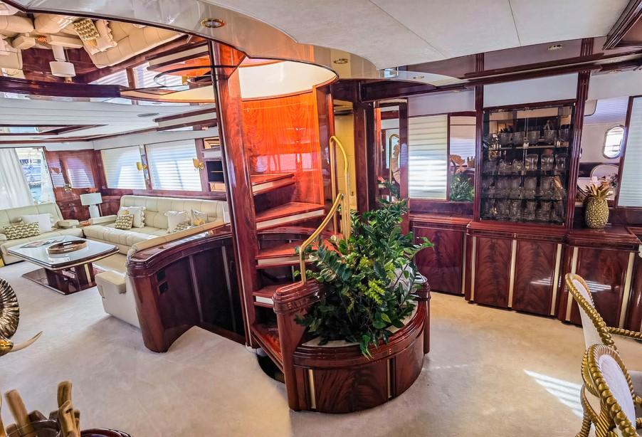 Luxurious interior of 1997 Astondoa 95 GLX yacht with elegant wood finishes and plush seating.