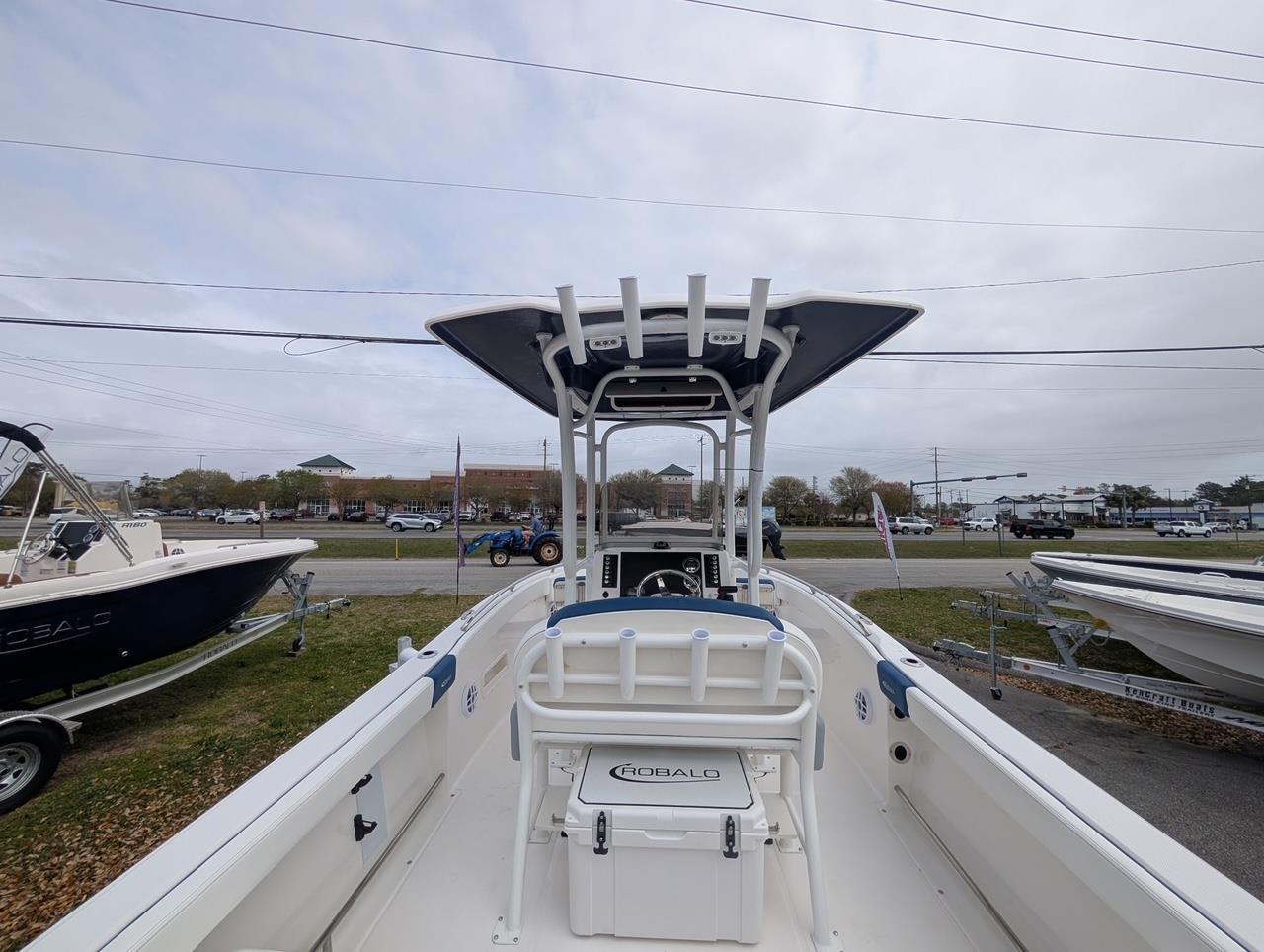 2025 Robalo R222 Explorer boat with T-top and console, displayed outdoors.