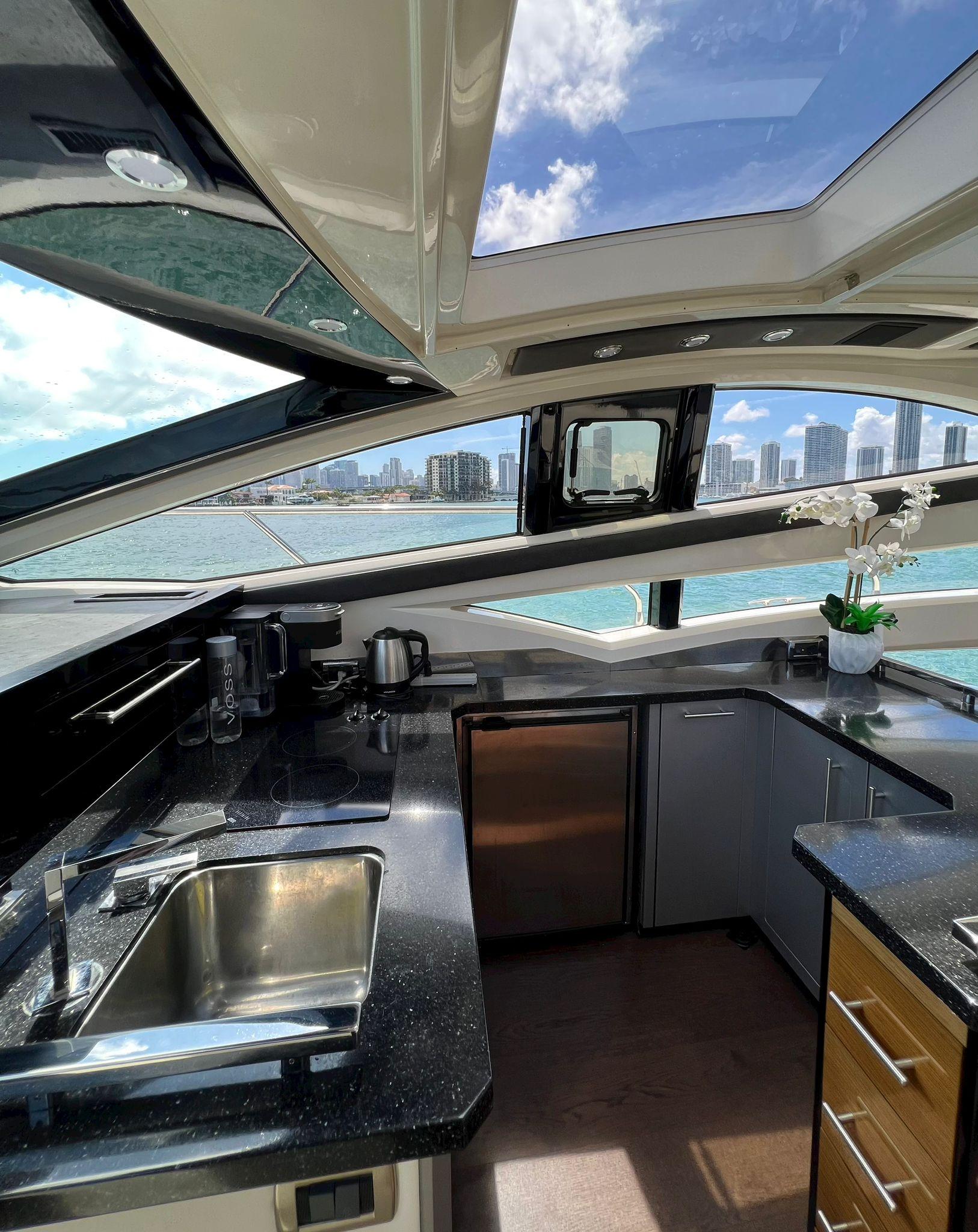 Interior of 2011 Marquis 500 Sport Coupe yacht with city skyline view.