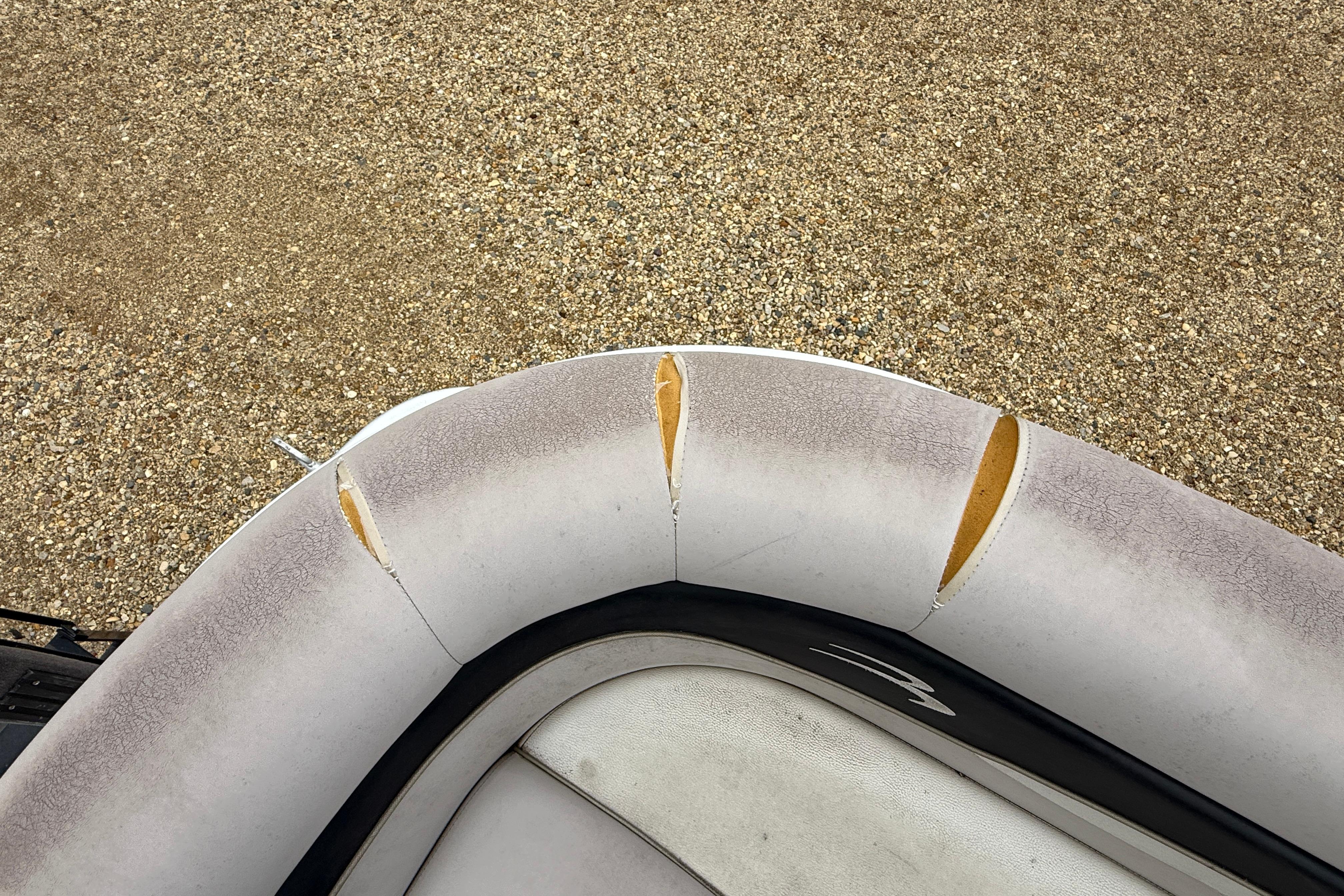 Damaged upholstery on 2010 Bennington 20SLi boat seat, showing wear and tears.