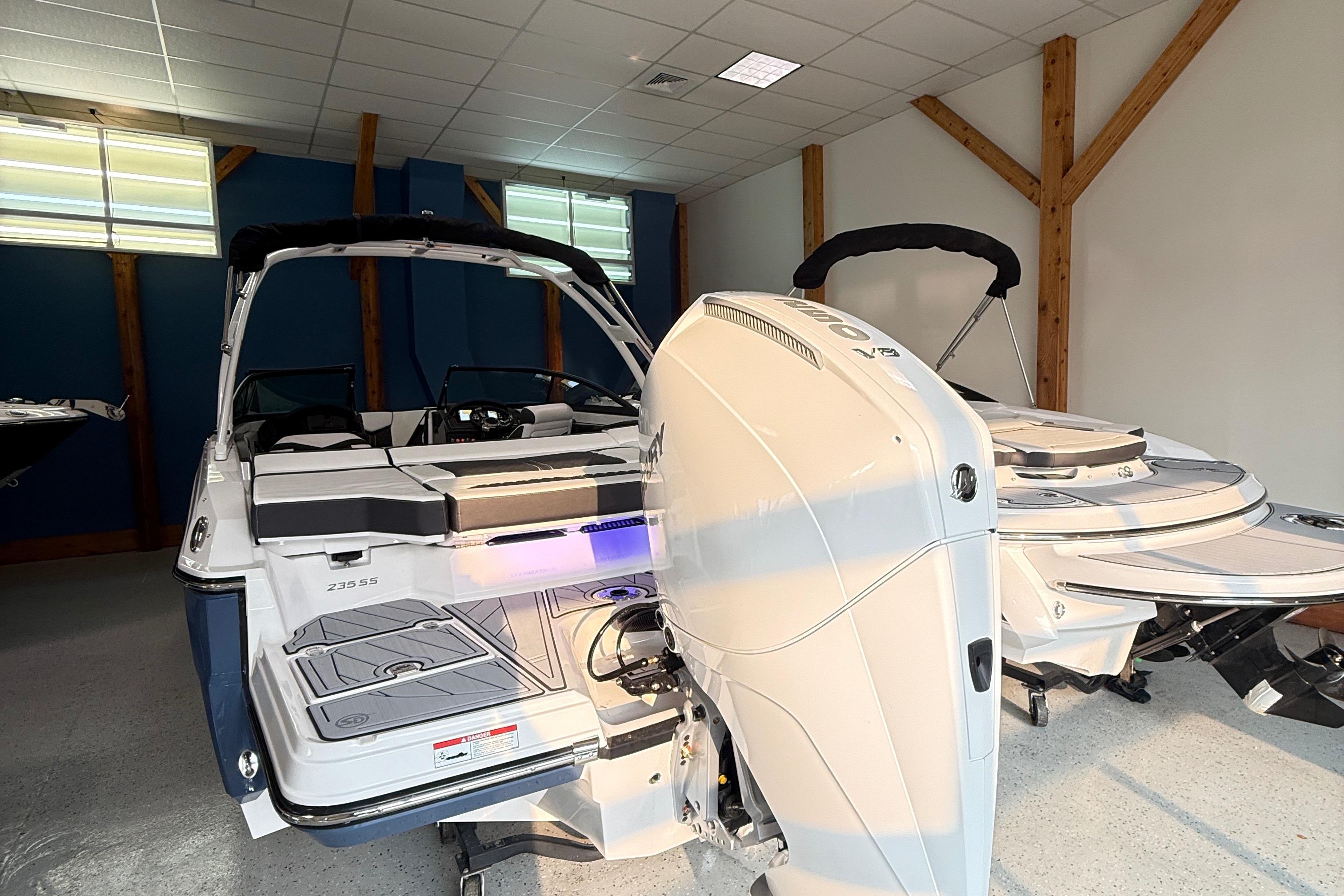 2025 Monterey 235SS Super Sport boat in showroom, featuring sleek design and powerful engine.