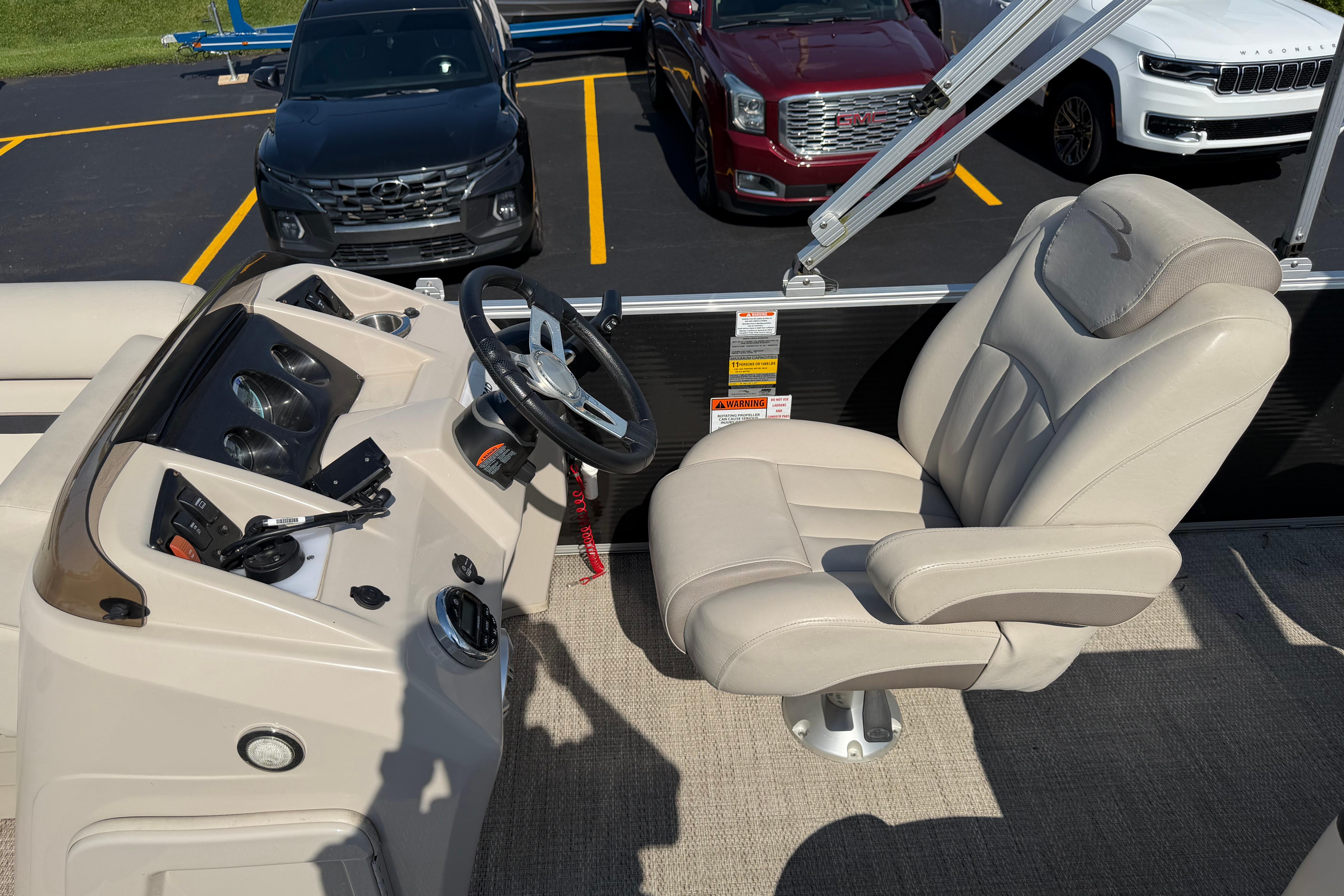 2018 Bennington 21 SF boat interior with steering wheel and captain's chair.