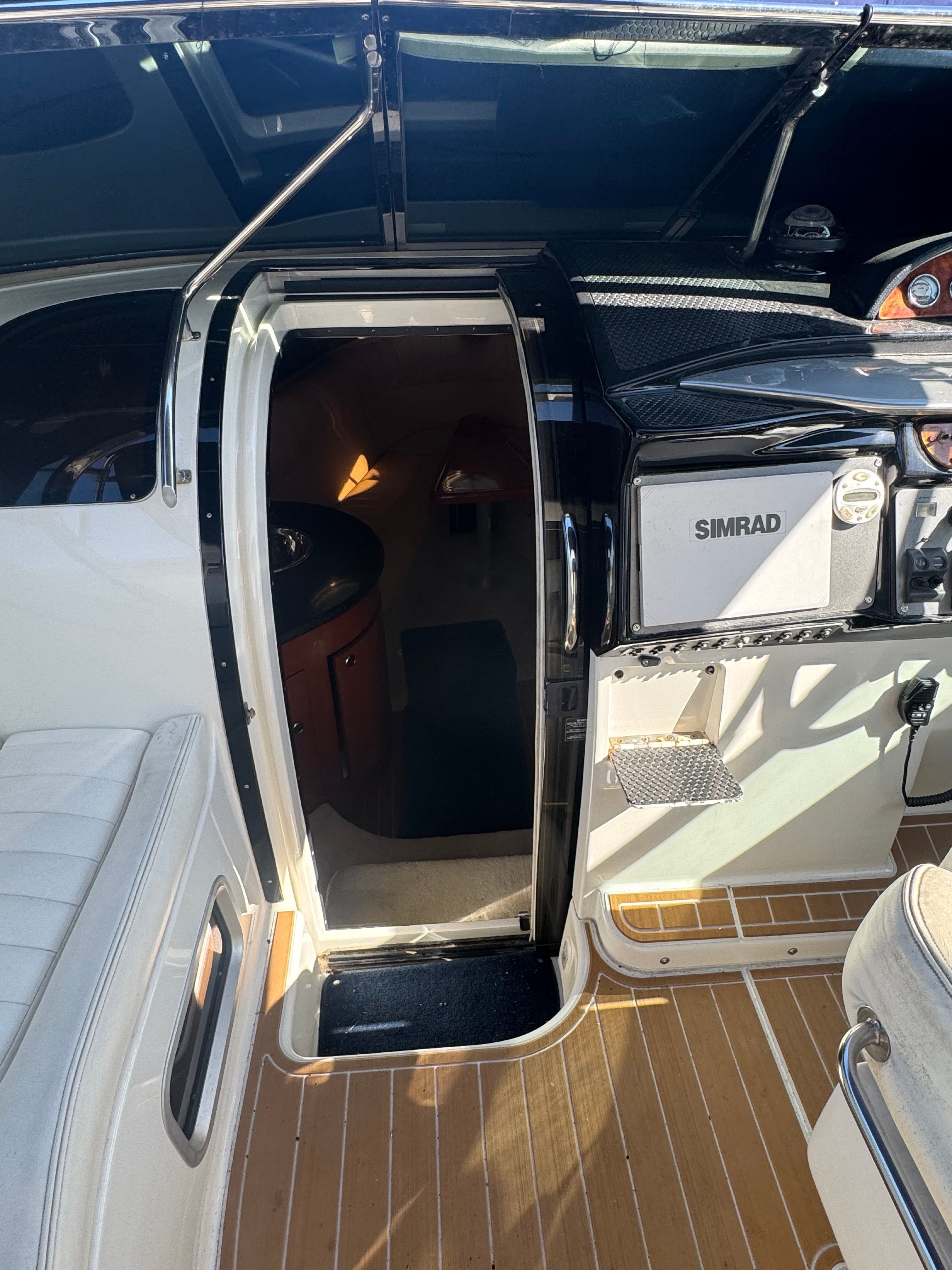 Entrance to the cabin of a 2003 Cobalt 360 with wood flooring and Simrad equipment.