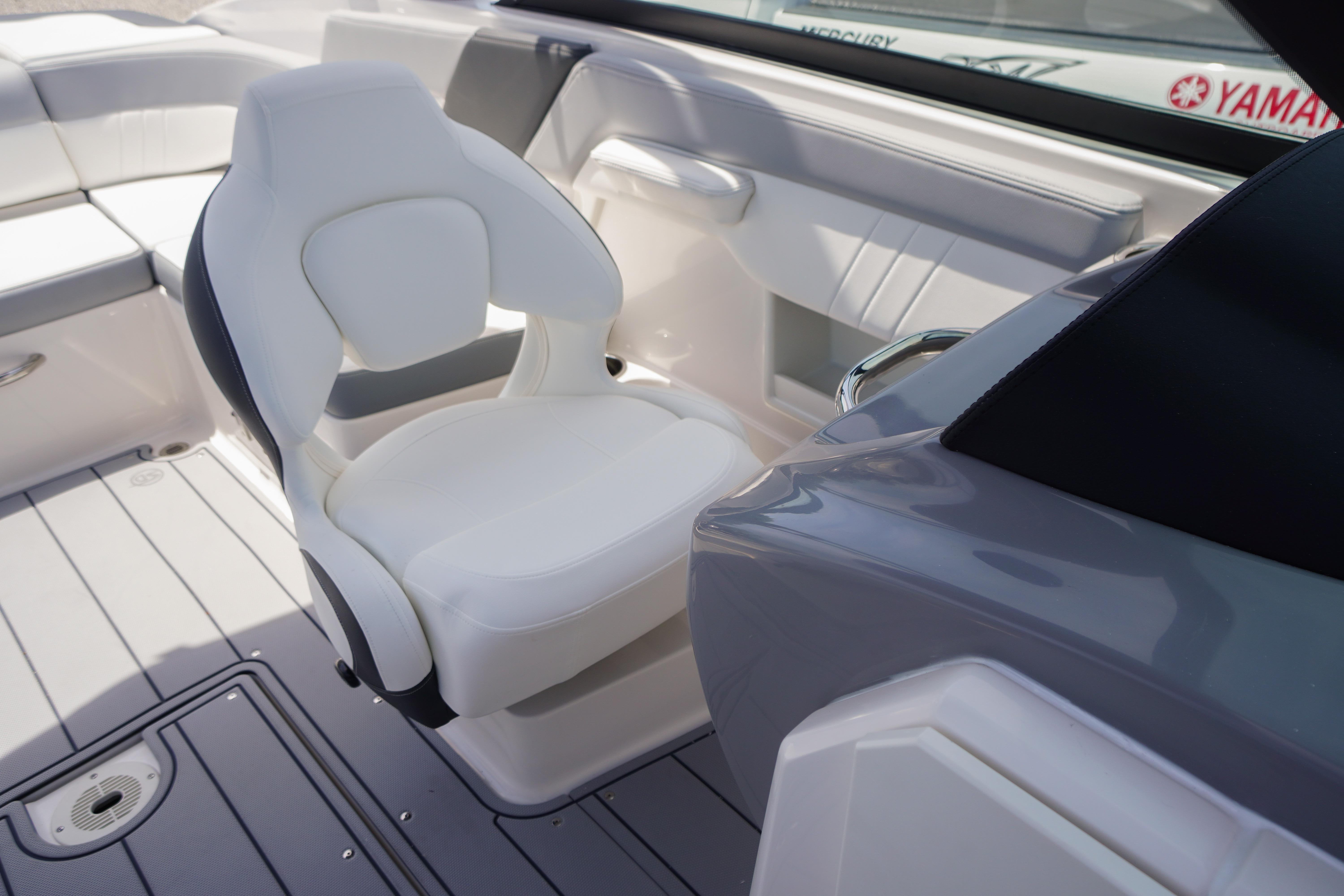 2026 Chaparral 23 SSi OB boat interior with white captain's chair and sleek design.