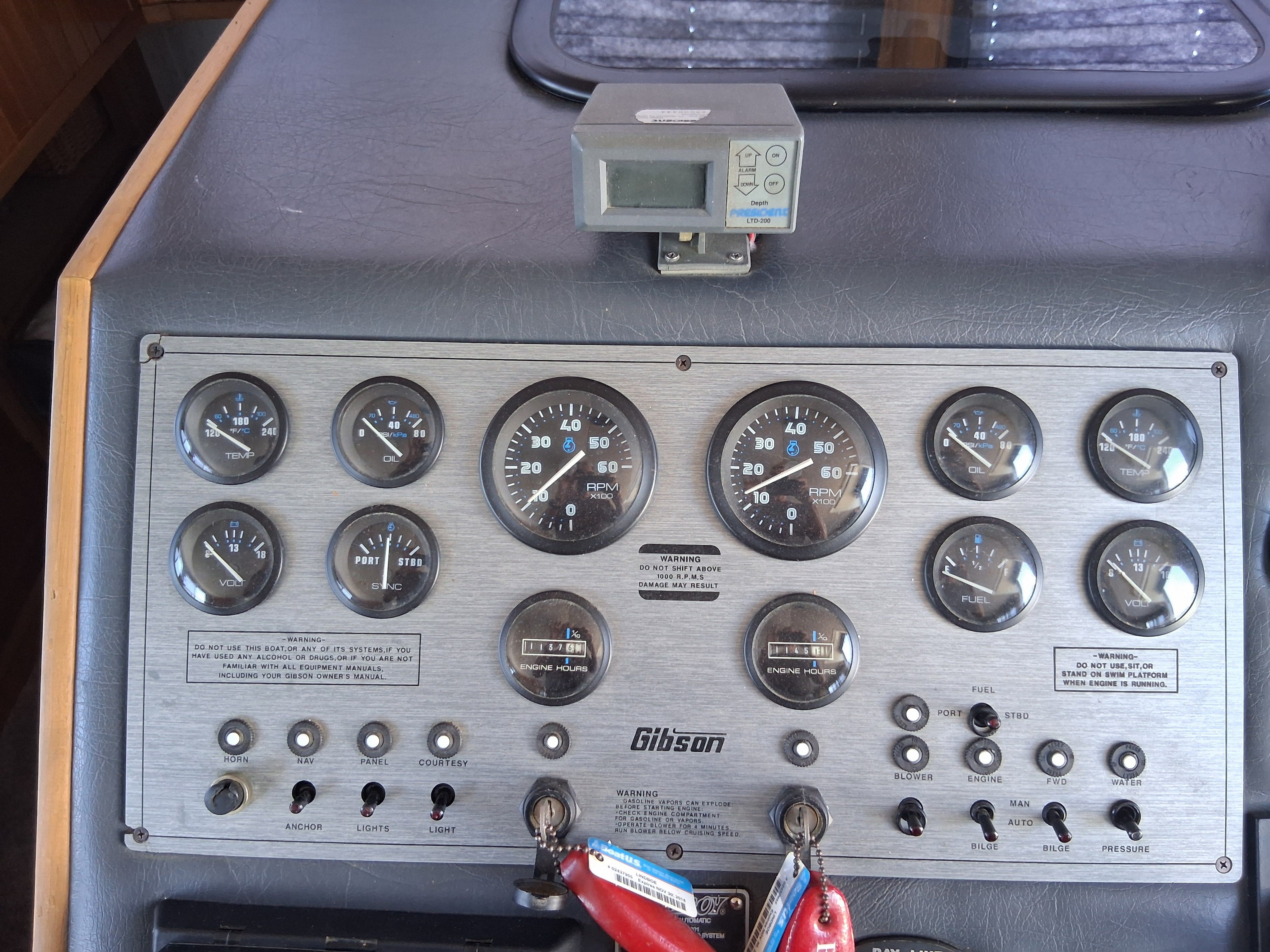 Dashboard of a 1993 Gibson 370 Sport with various gauges and switches.