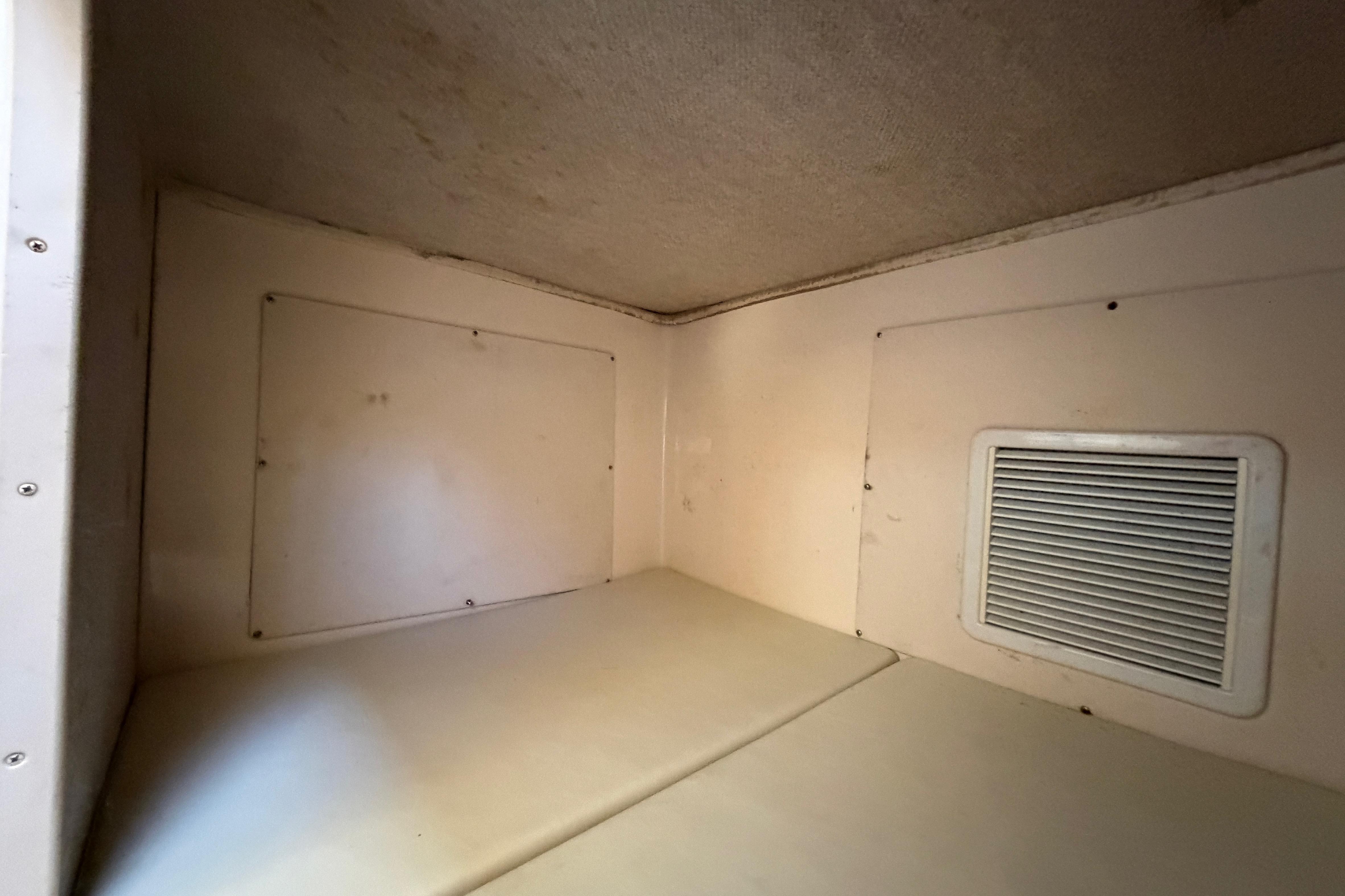 Interior cabin of 2006 Grady-White Sailfish 282 boat, featuring a vented wall.