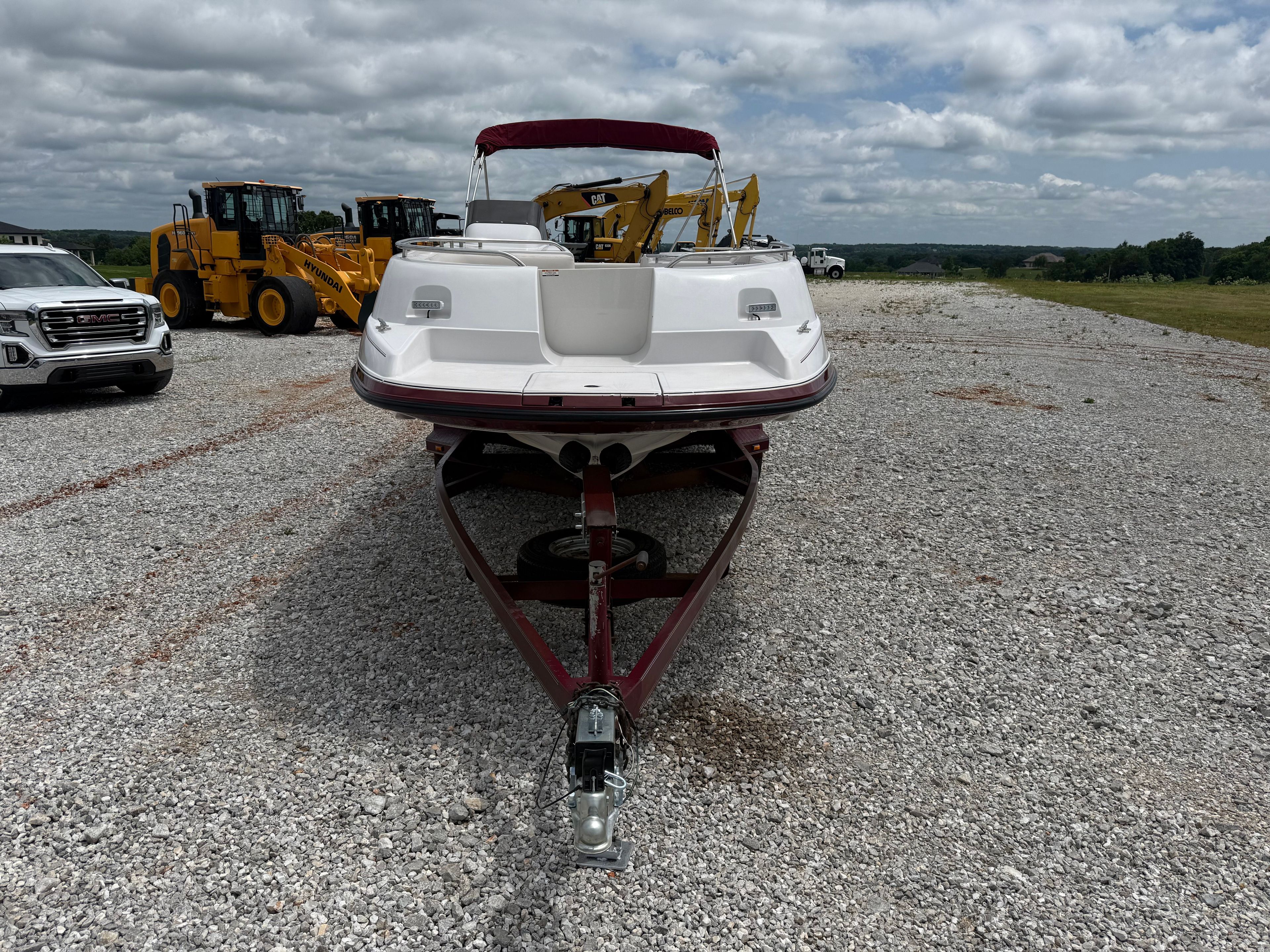 A 1994 Chaparral Sunesta 220 on a trailer in a gravel lot.