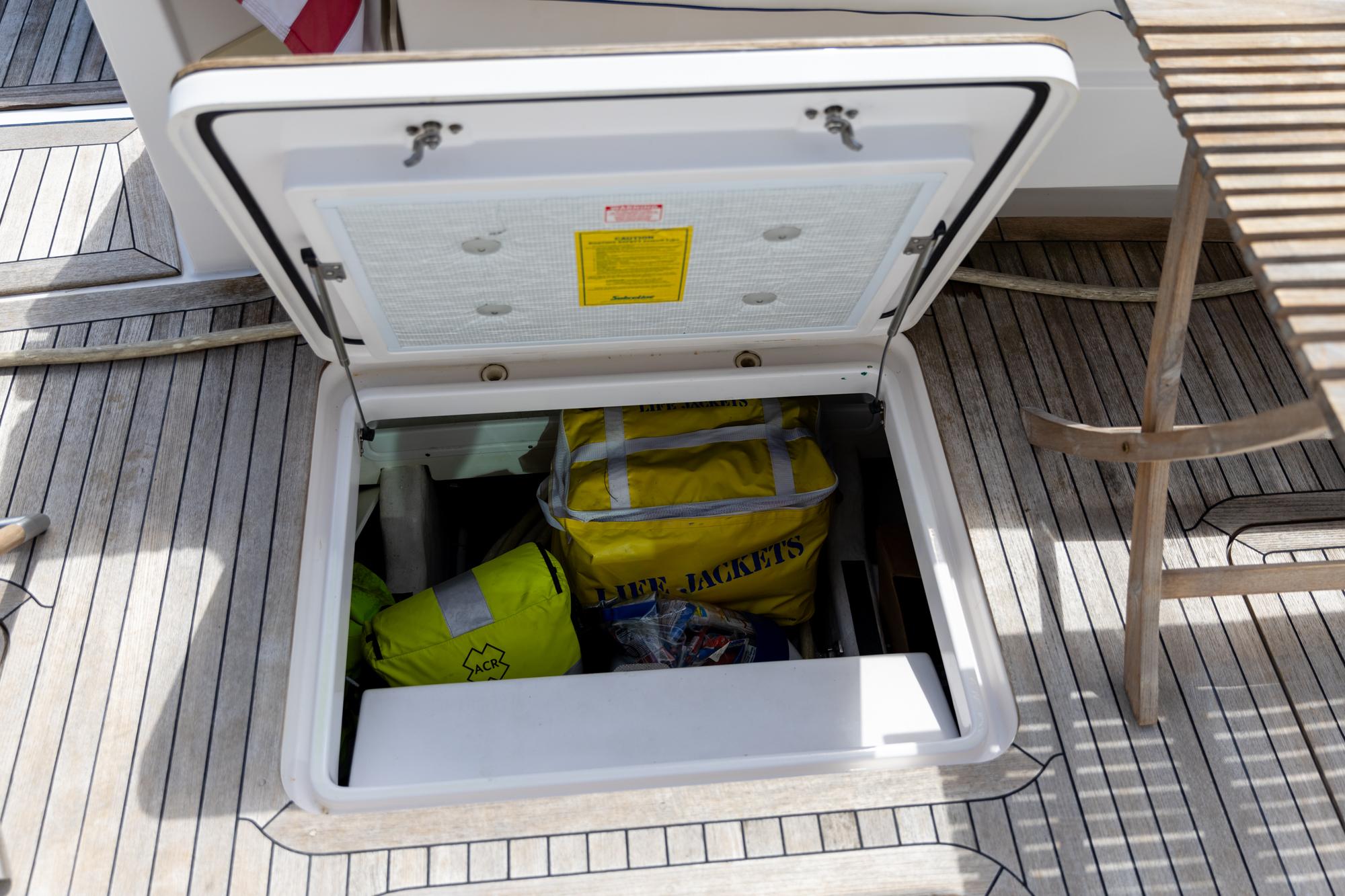 Open storage hatch on 2009 Sabre 52 Express yacht, containing life jackets.