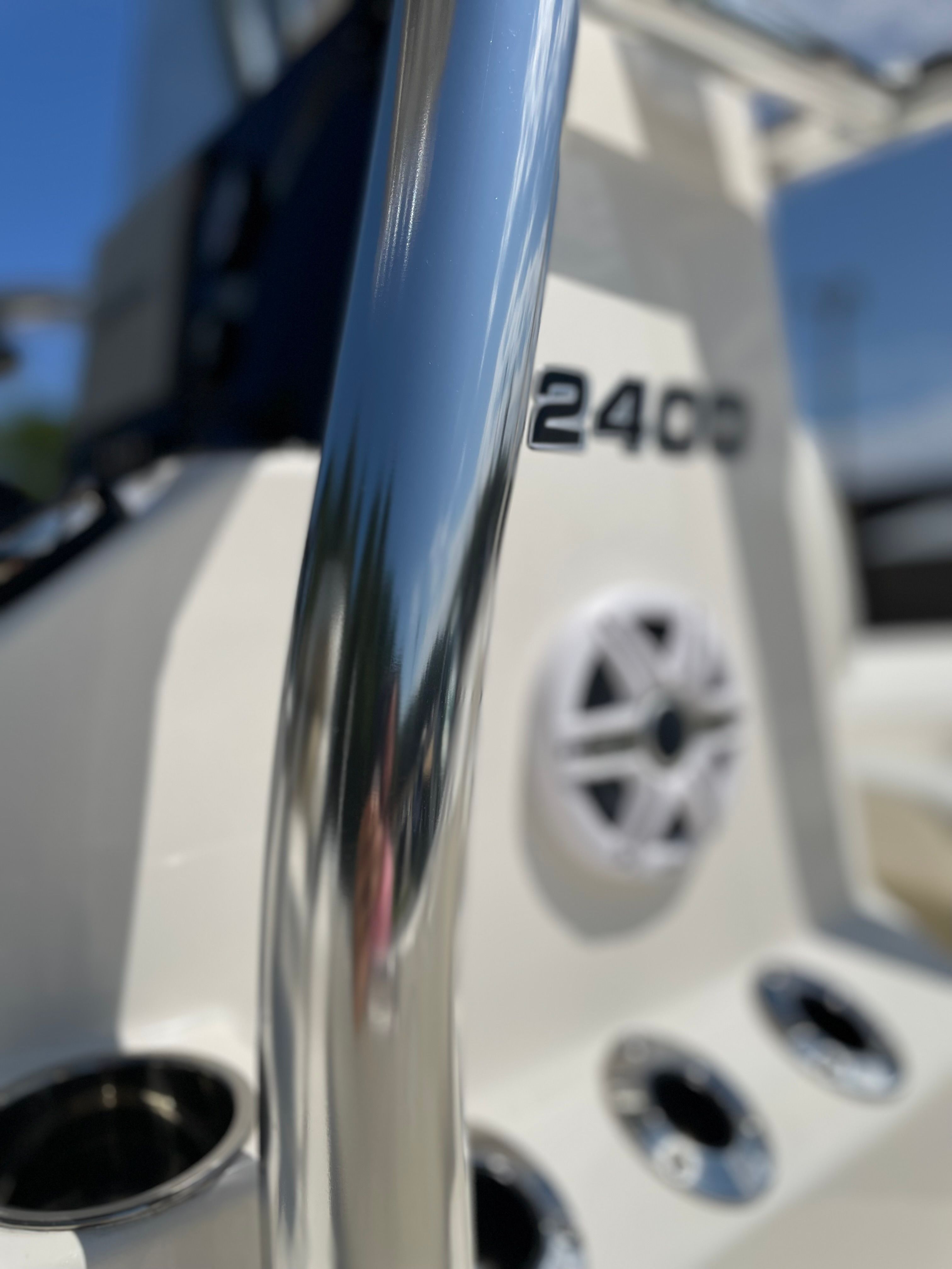 Close-up of a boat detail with shiny metal railing and the text "2400."