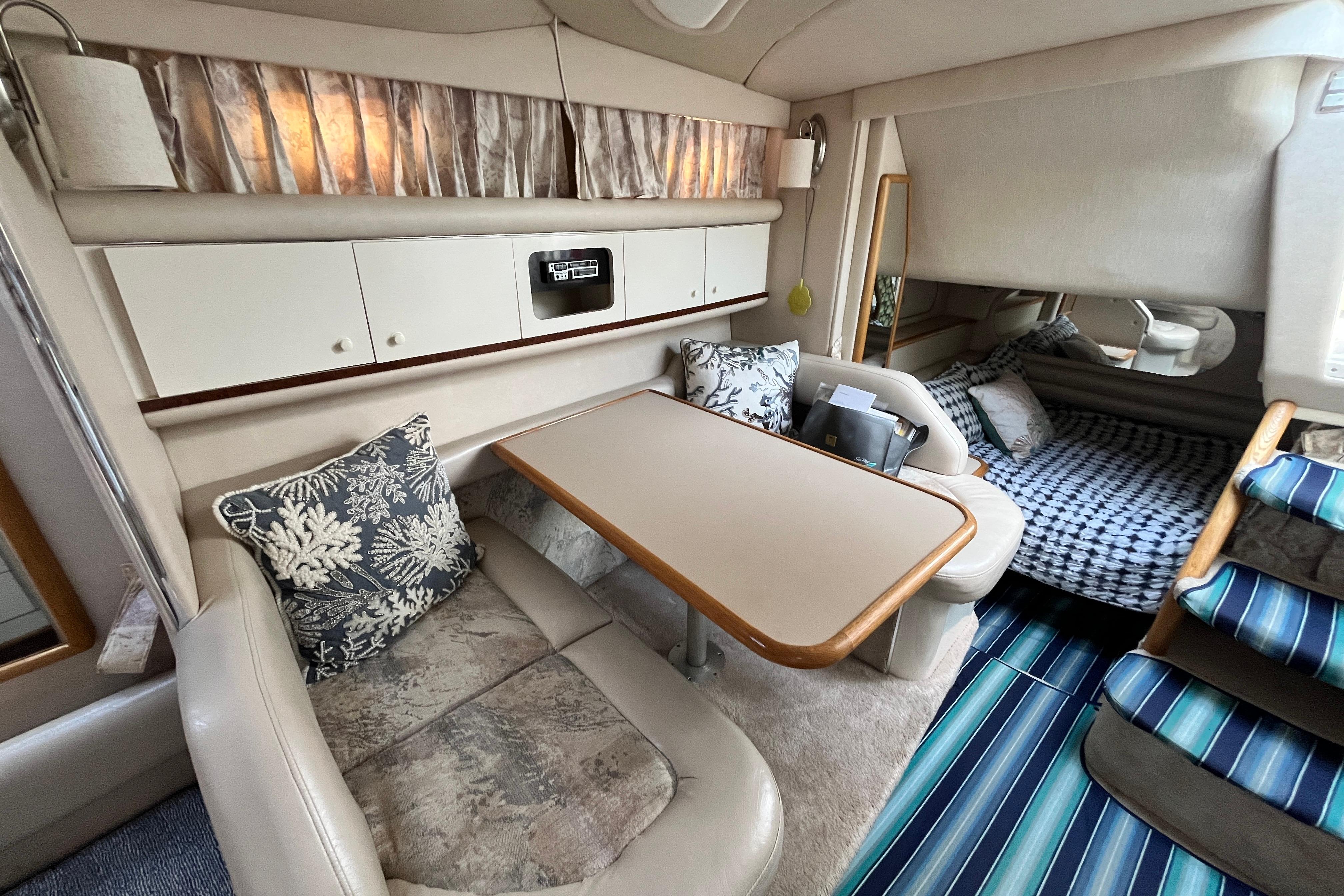Interior of 1995 Sea Ray Sundancer 330 with cozy seating and dining area.