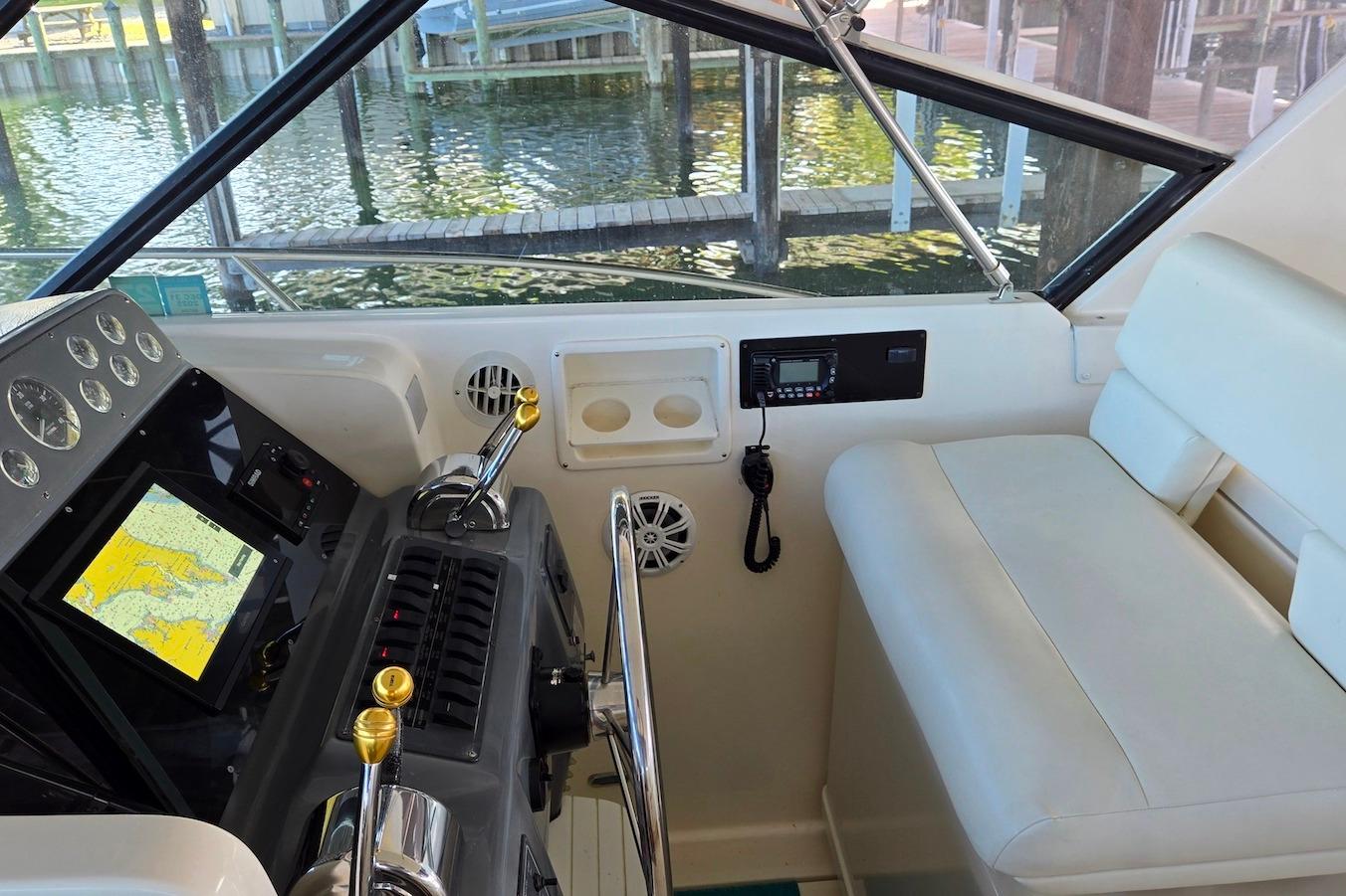 1996 Tiara Yachts 3700 Open helm with navigation equipment and seating.