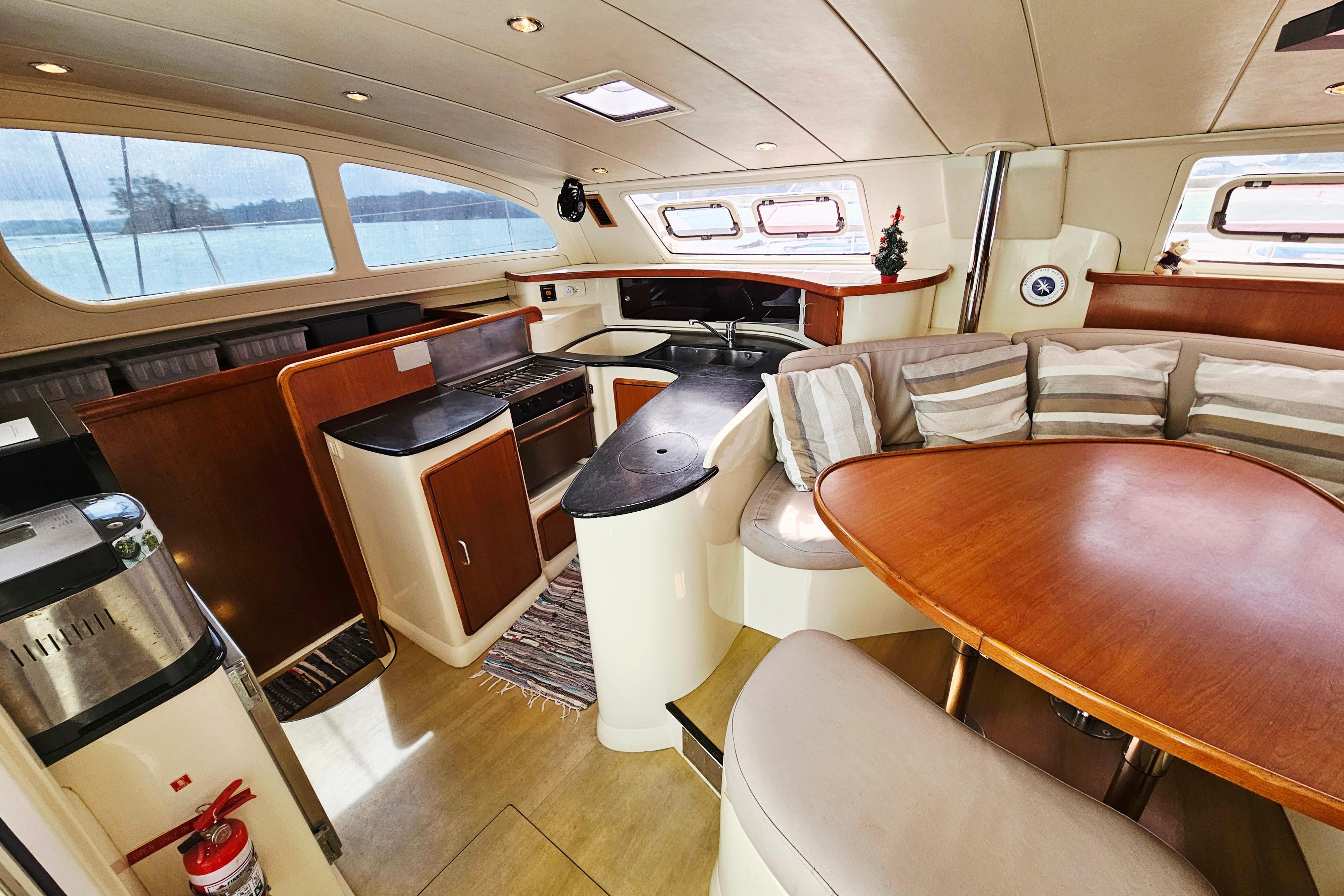 Luxurious interior of a 2007 Leopard 43 yacht with modern kitchen and seating area.