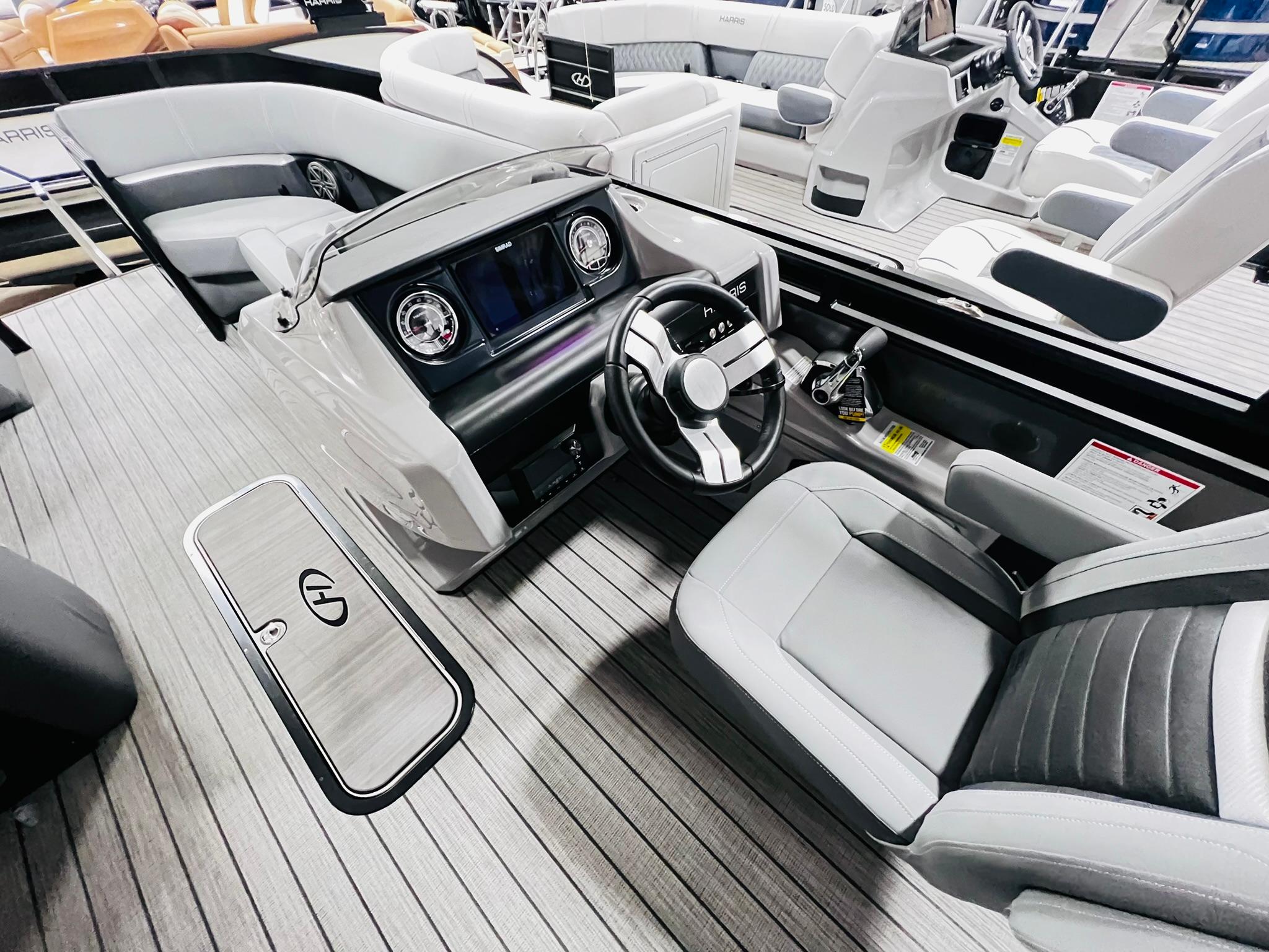 2024 Harris Solstice 230 boat interior with modern dashboard and seating.