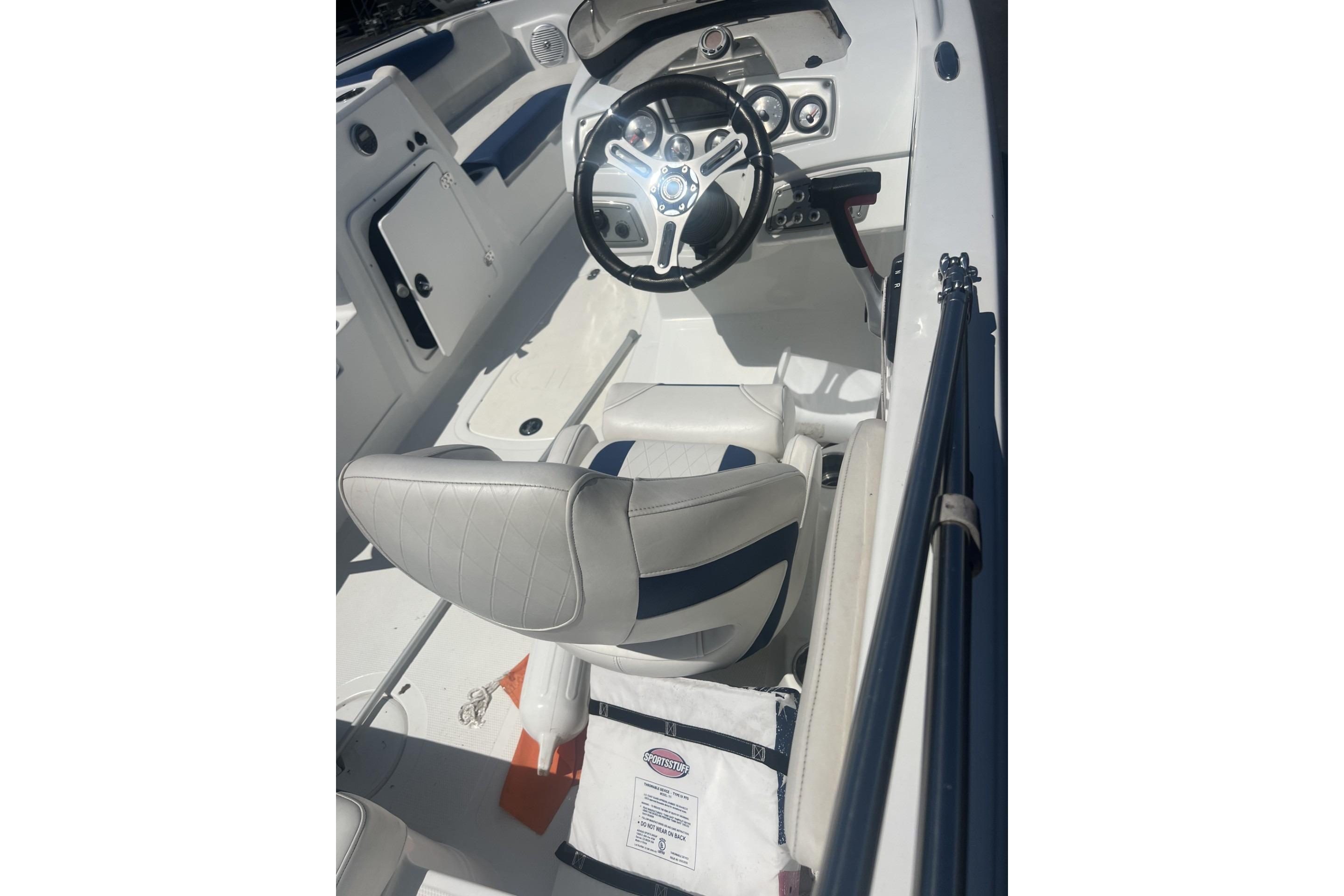 2017 Tahoe 2150 boat interior with steering wheel and seating.