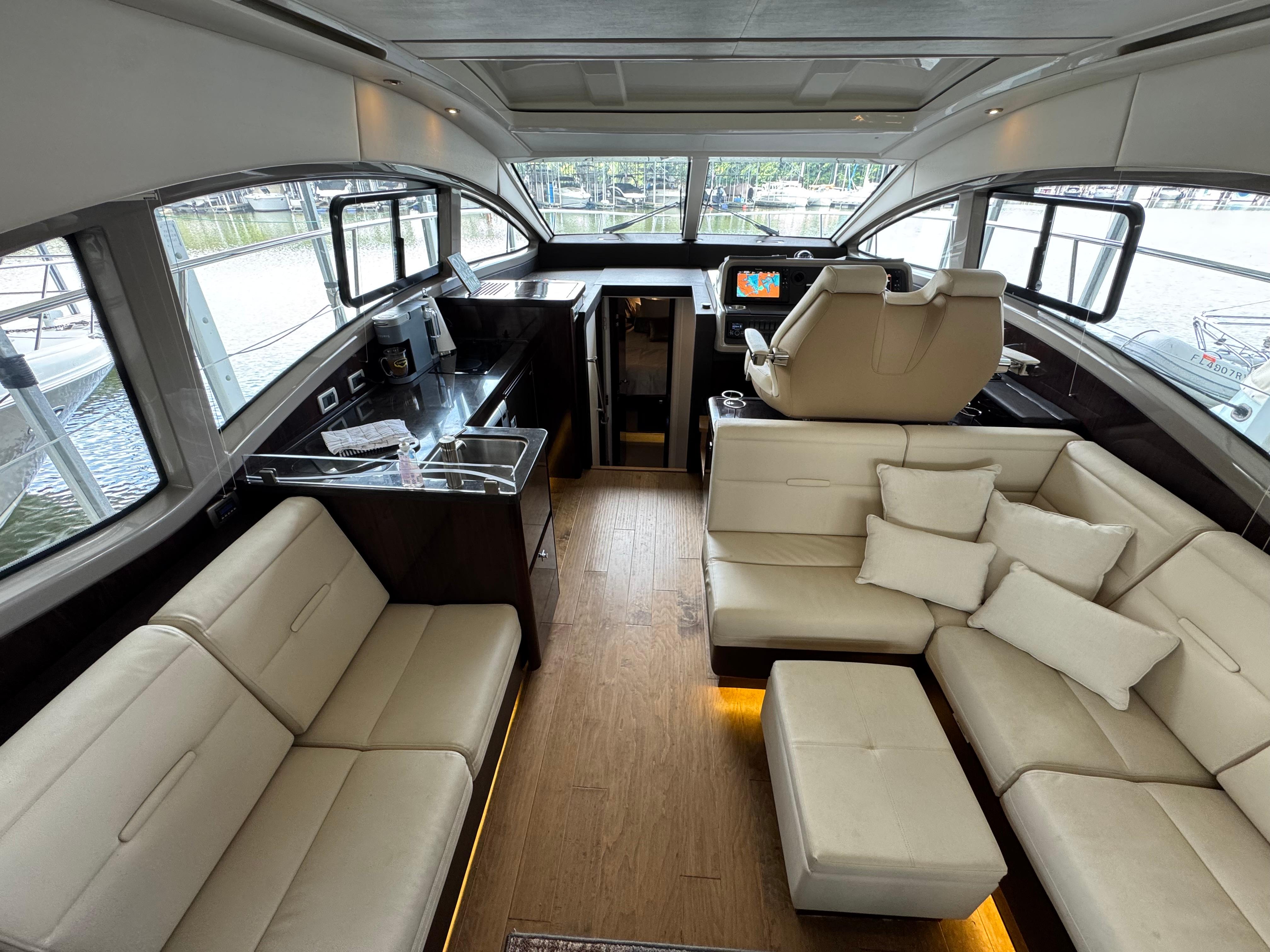 Luxurious interior of 2017 Sea Ray Sundancer 400 yacht with plush seating and modern helm.