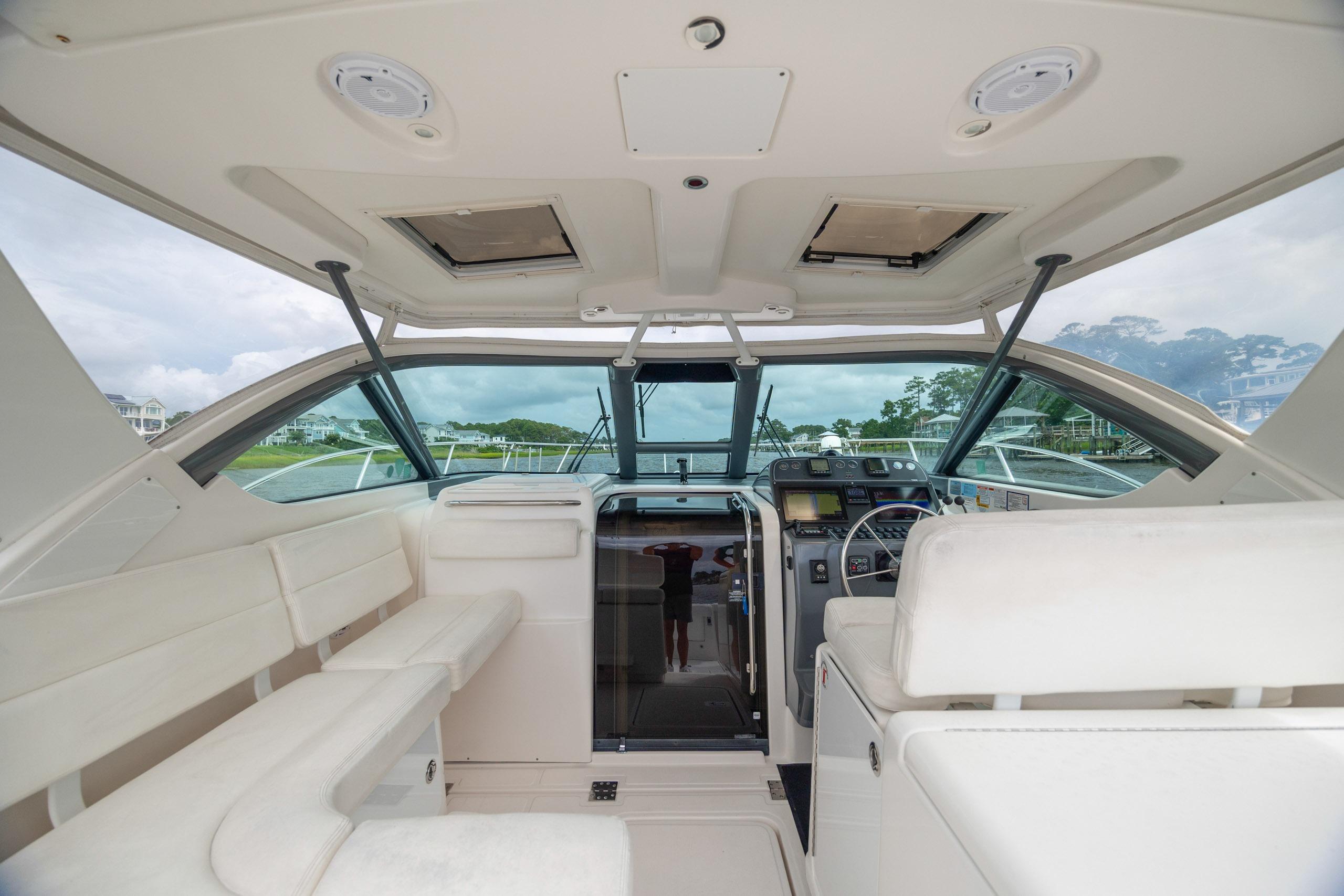 2004 Tiara Yachts 3200 Open interior with helm, seating, and panoramic windows.