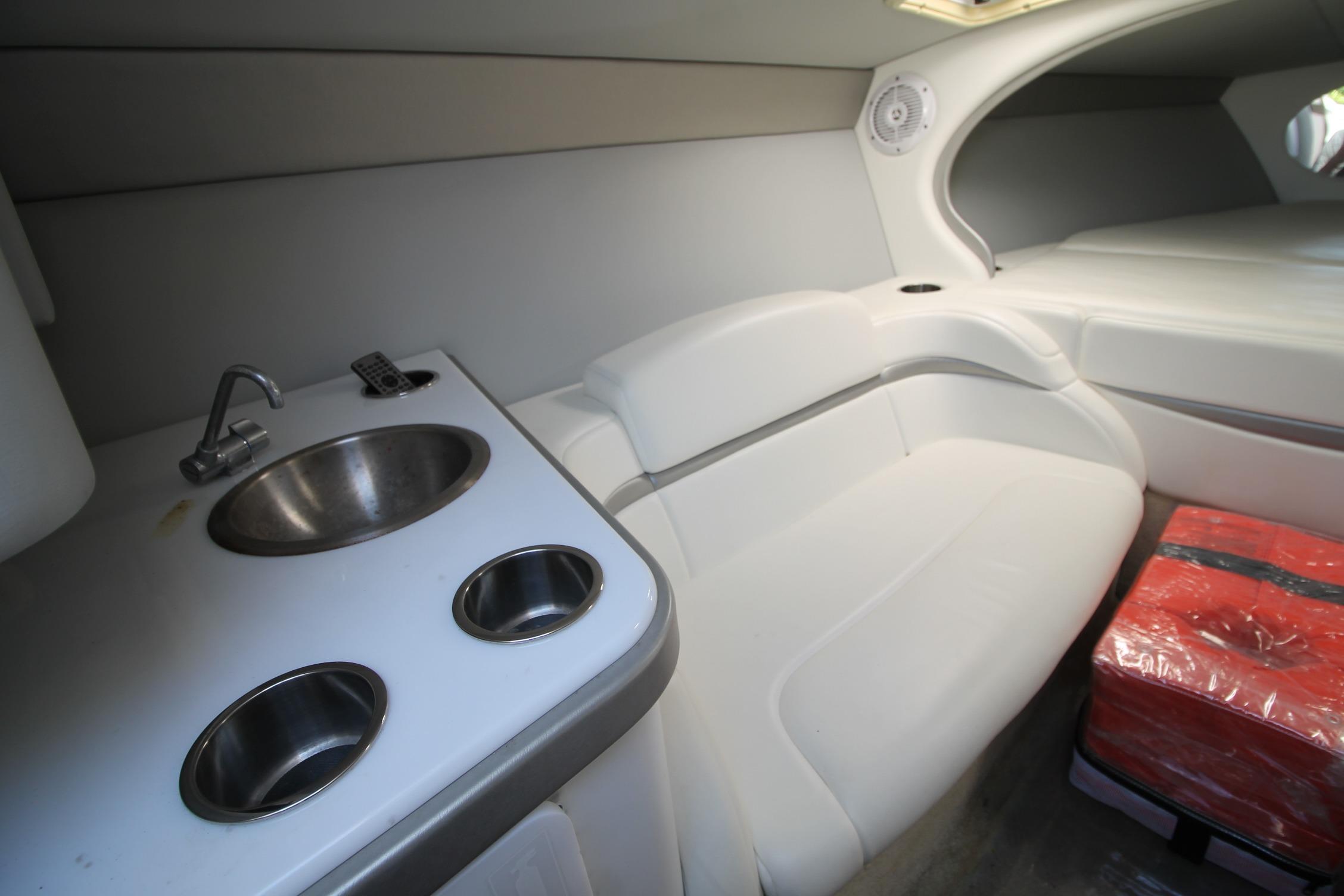 Interior of 2006 Formula 292 FASTech boat with sink, seating, and storage area.