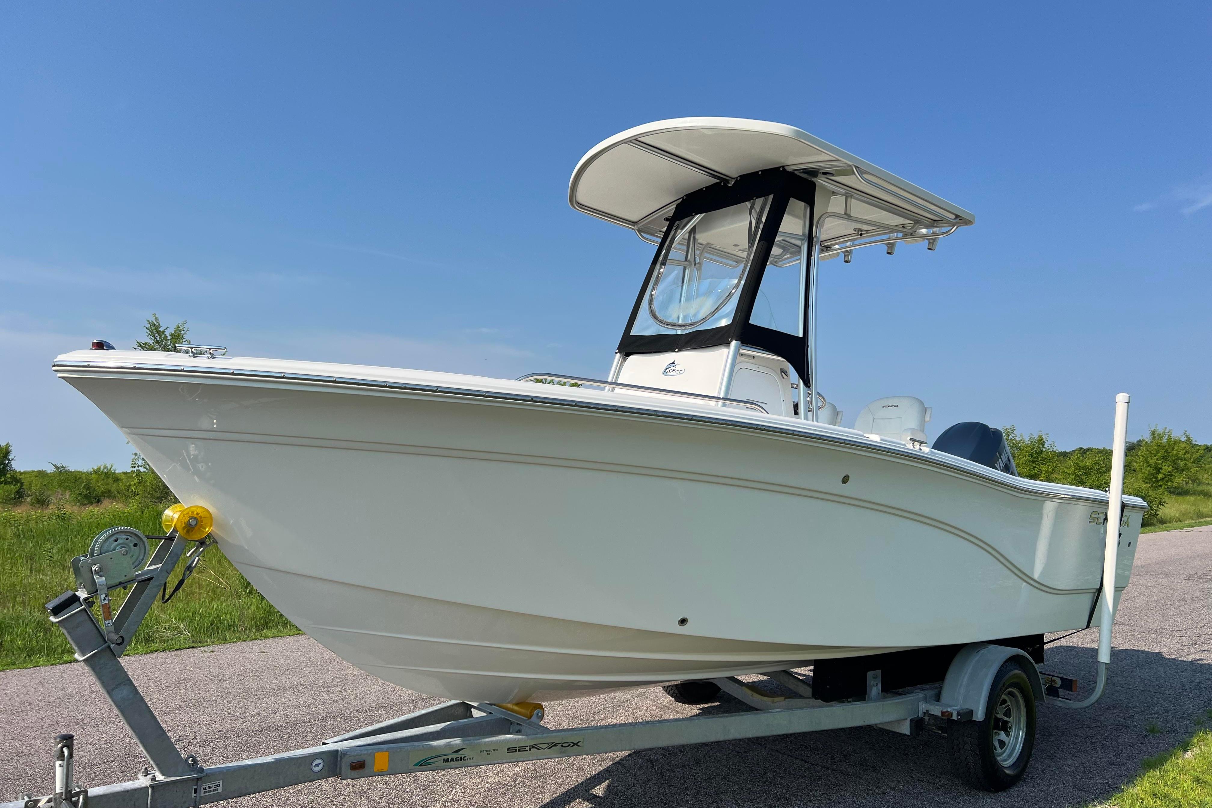 2012 Sea Fox 206 Center Console boat on trailer, parked on a sunny day.