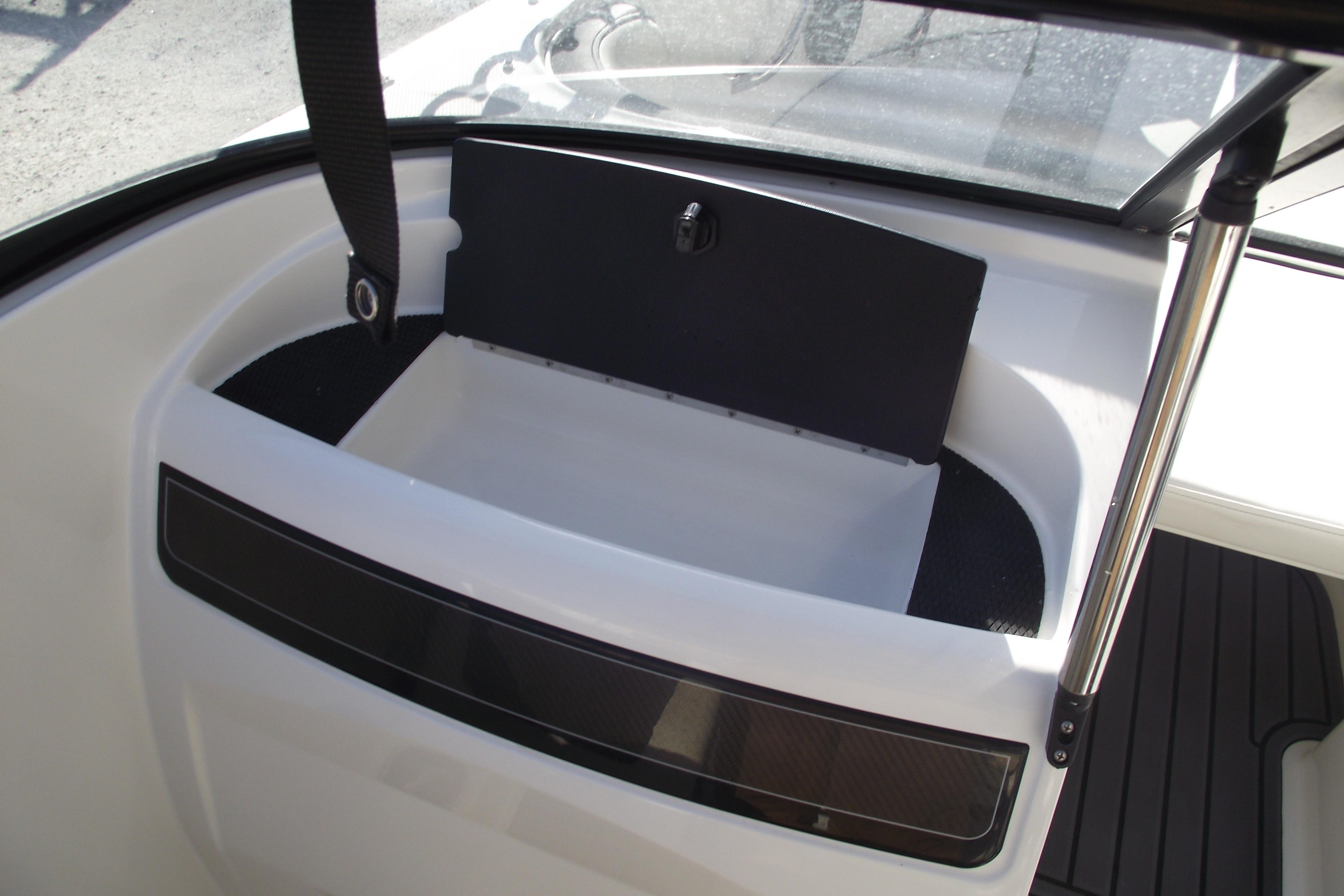 2022 Bayliner VR4 Bowrider OB interior storage compartment with open lid.