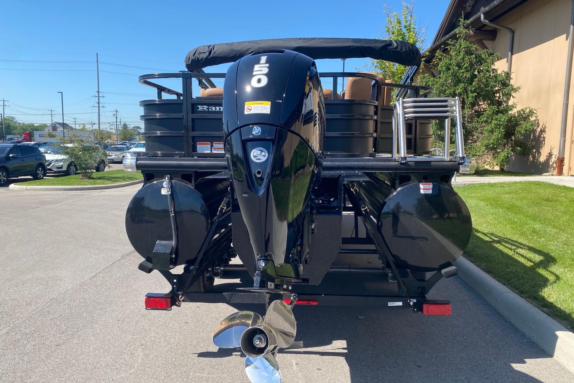 2026 Ranger 223F boat with powerful outboard motor, parked outdoors on a sunny day.