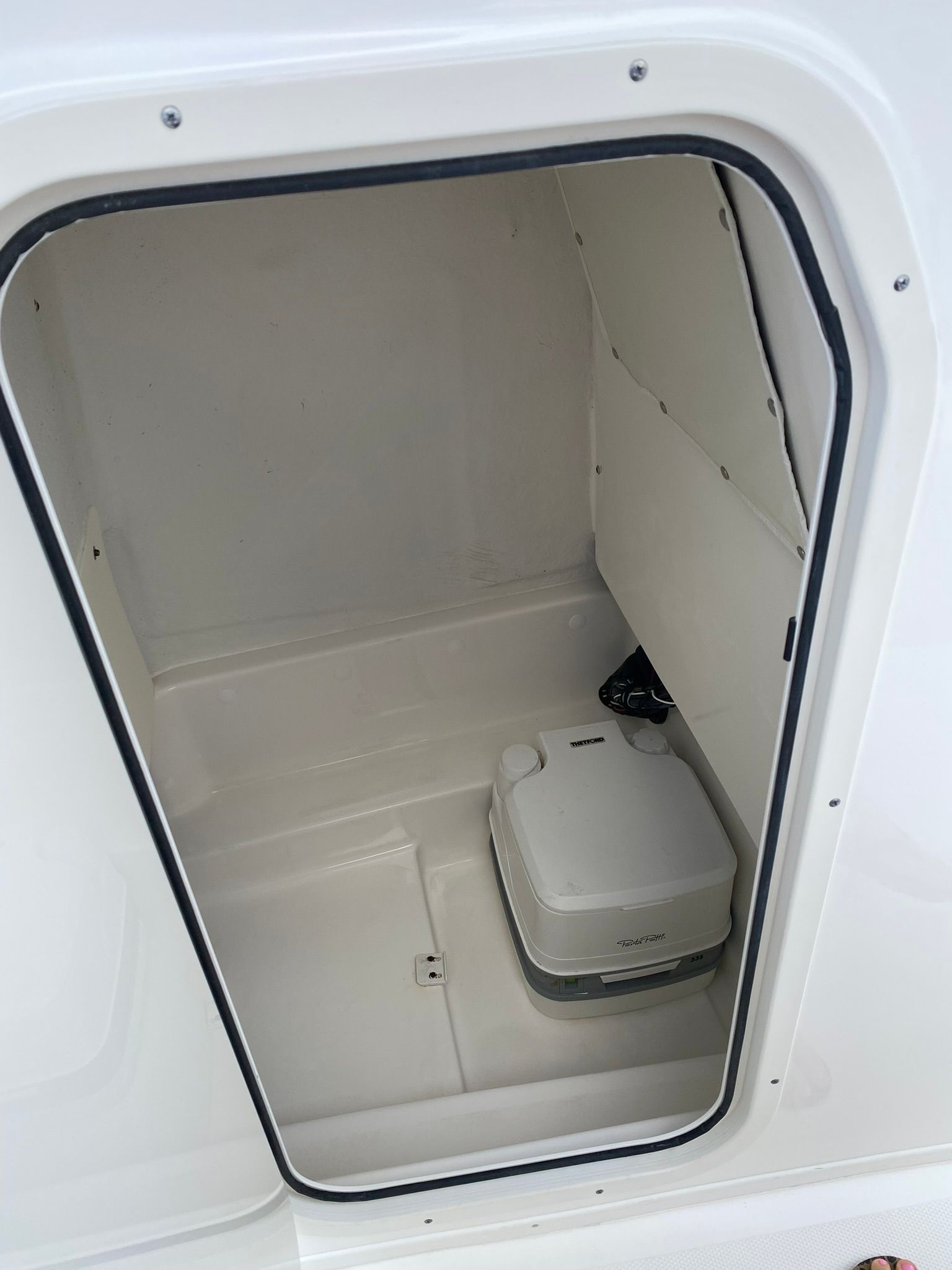 Interior of a 2021 NauticStar Legacy with portable toilet.