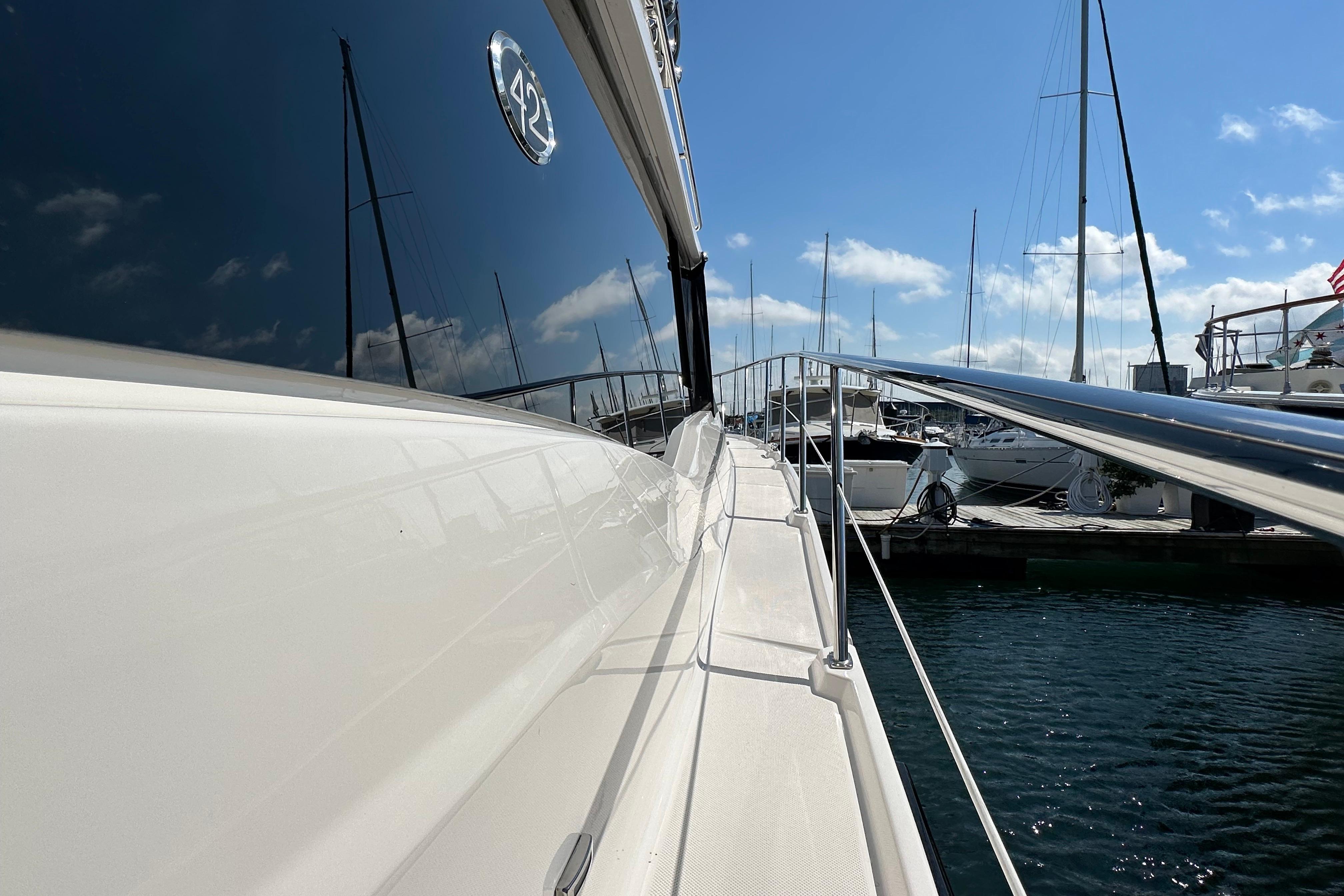 2019 Regal 42 Fly yacht docked at marina under clear blue sky.