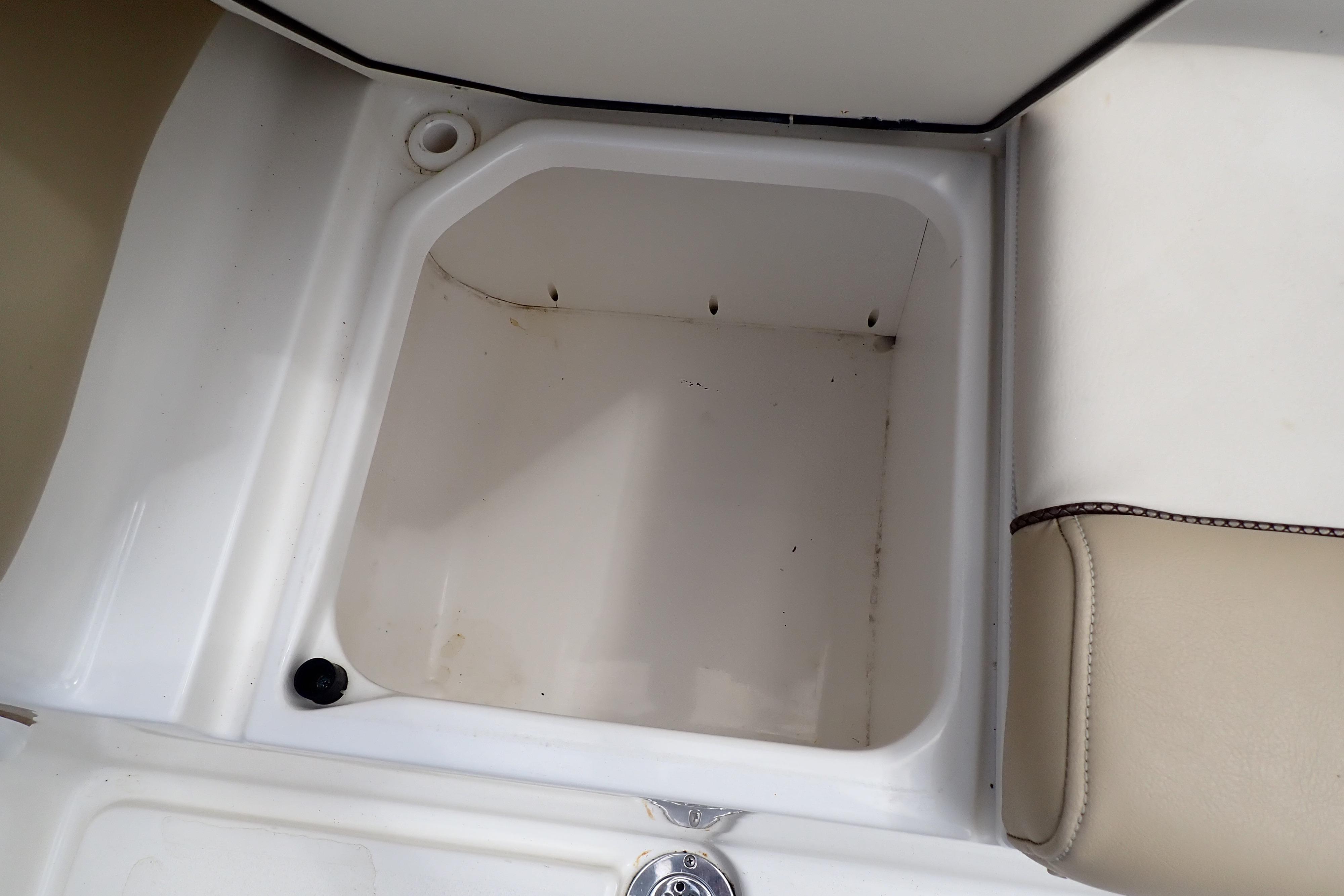 Storage compartment in a 2019 Key West 263 FS boat, featuring white and beige interior.
