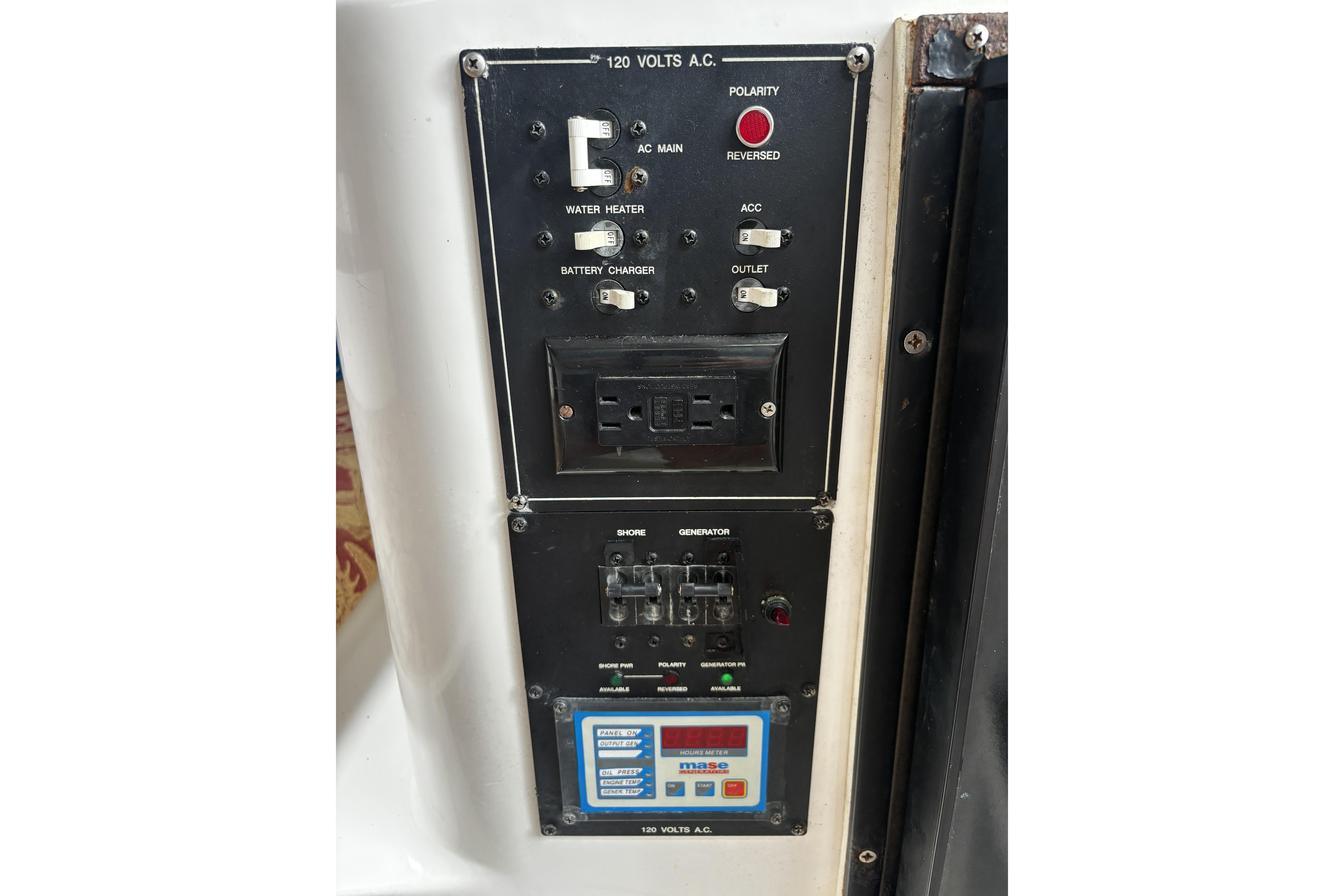 Electrical control panel on a 2005 Prosports 2860 KATWA boat, featuring switches and outlets.