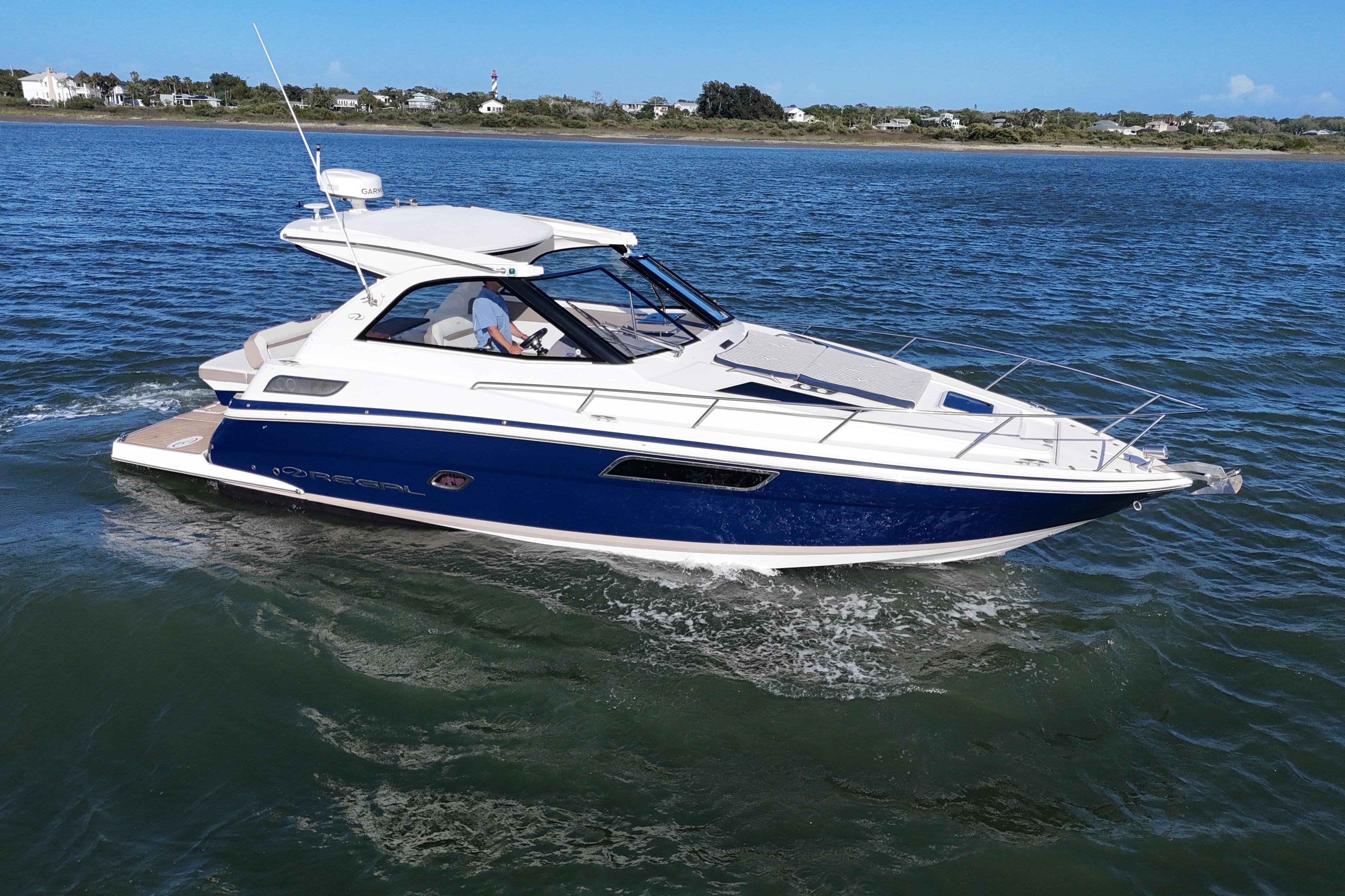 2016 Regal 35 Sport Coupe cruising on open water, showcasing sleek design and luxury features.