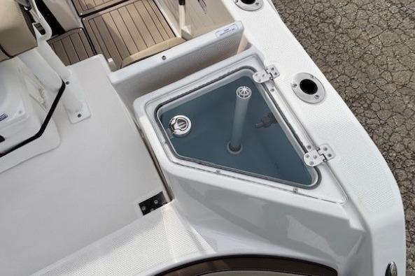 2026 Yamaha Boats 222 FSH Sport E deck with storage compartment and seating area.