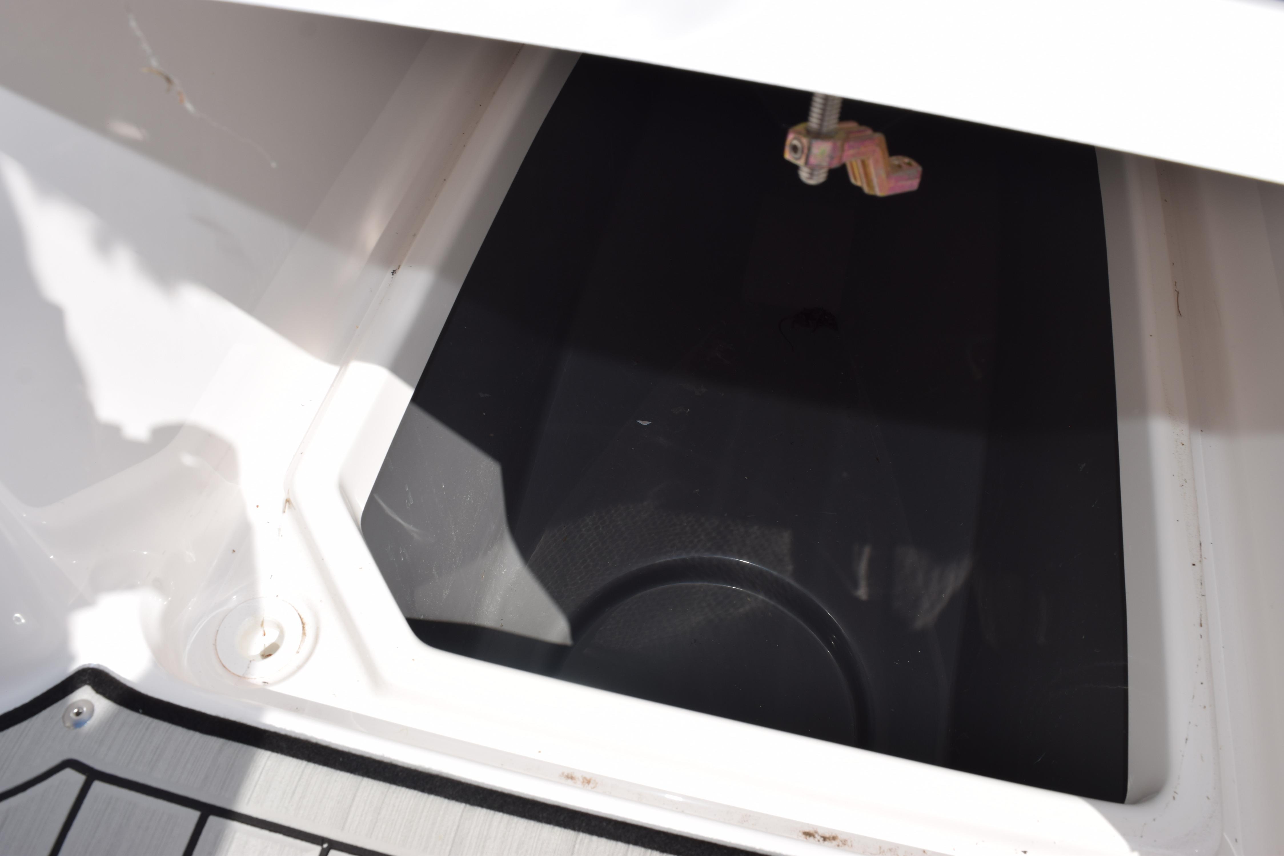 Storage compartment of 2026 Yamaha Boats 255 FSH Sport H, featuring sleek design.