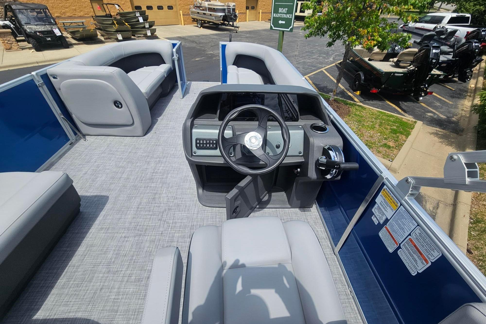 2026 Sun Tracker Party Barge 18 DLX interior with steering console and seating.