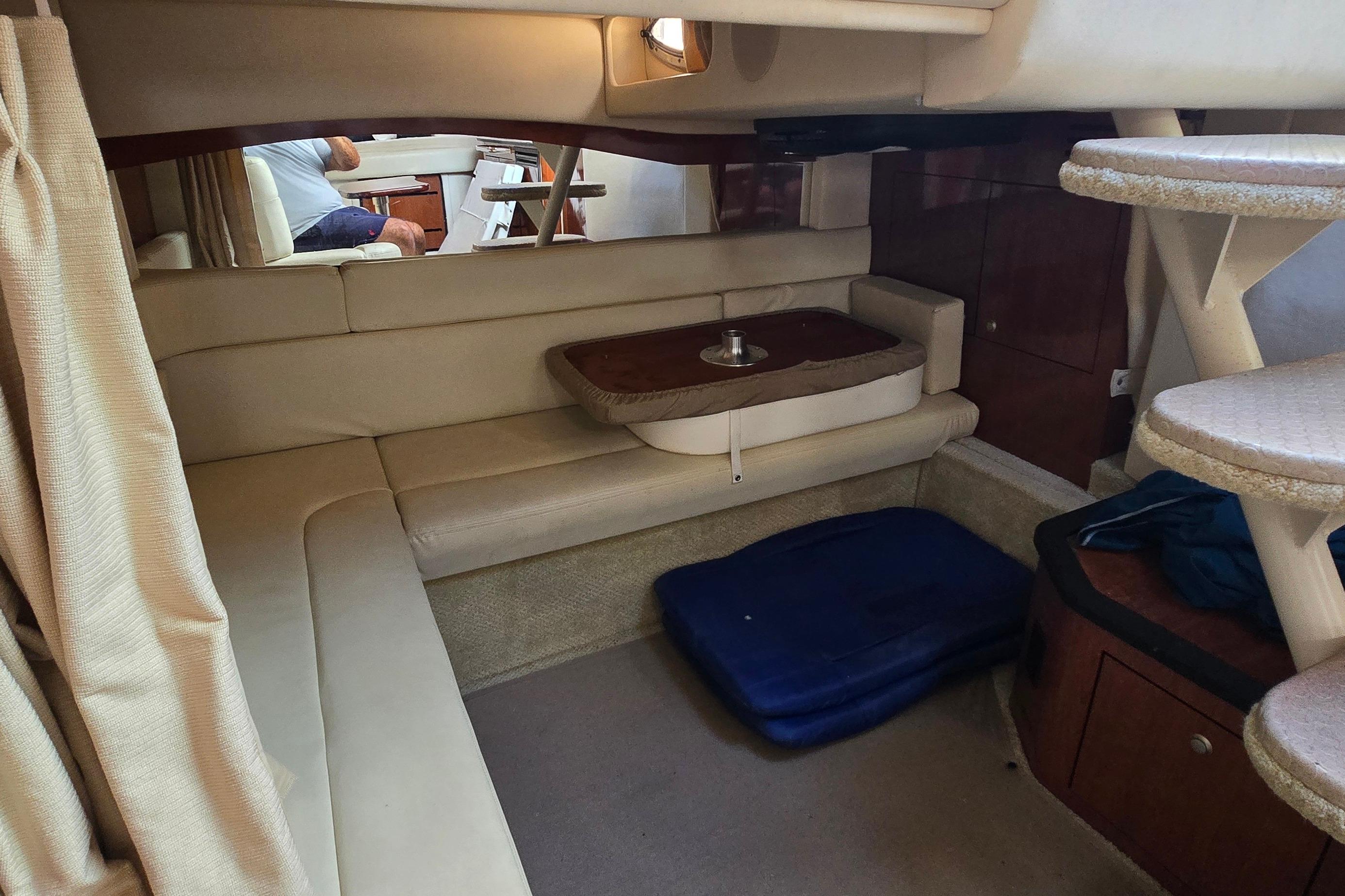 Interior of 2007 Sea Ray 340 Sundancer yacht with beige seating and compact dining area.