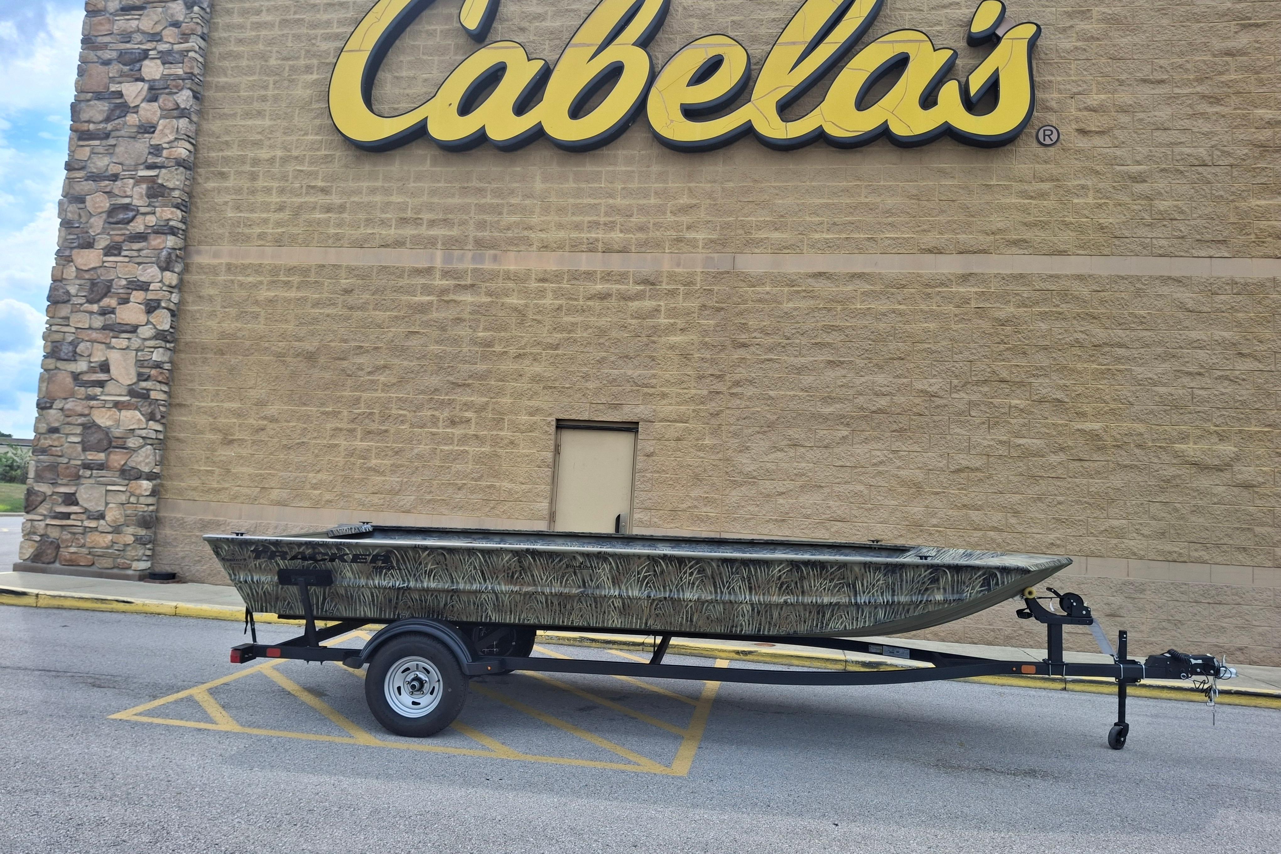 2026 Tracker Grizzly 1860 Utility boat on trailer outside Cabela's store.