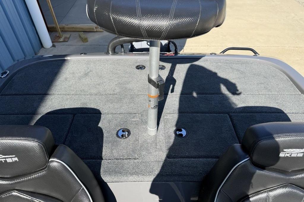 2026 Skeeter ZX150 boat interior with cushioned seats and carpeted deck.