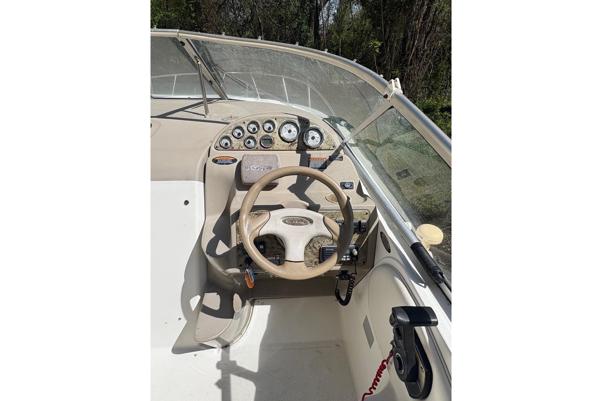 2001 Bayliner 2655 Ciera boat dashboard with steering wheel and instrument panel.