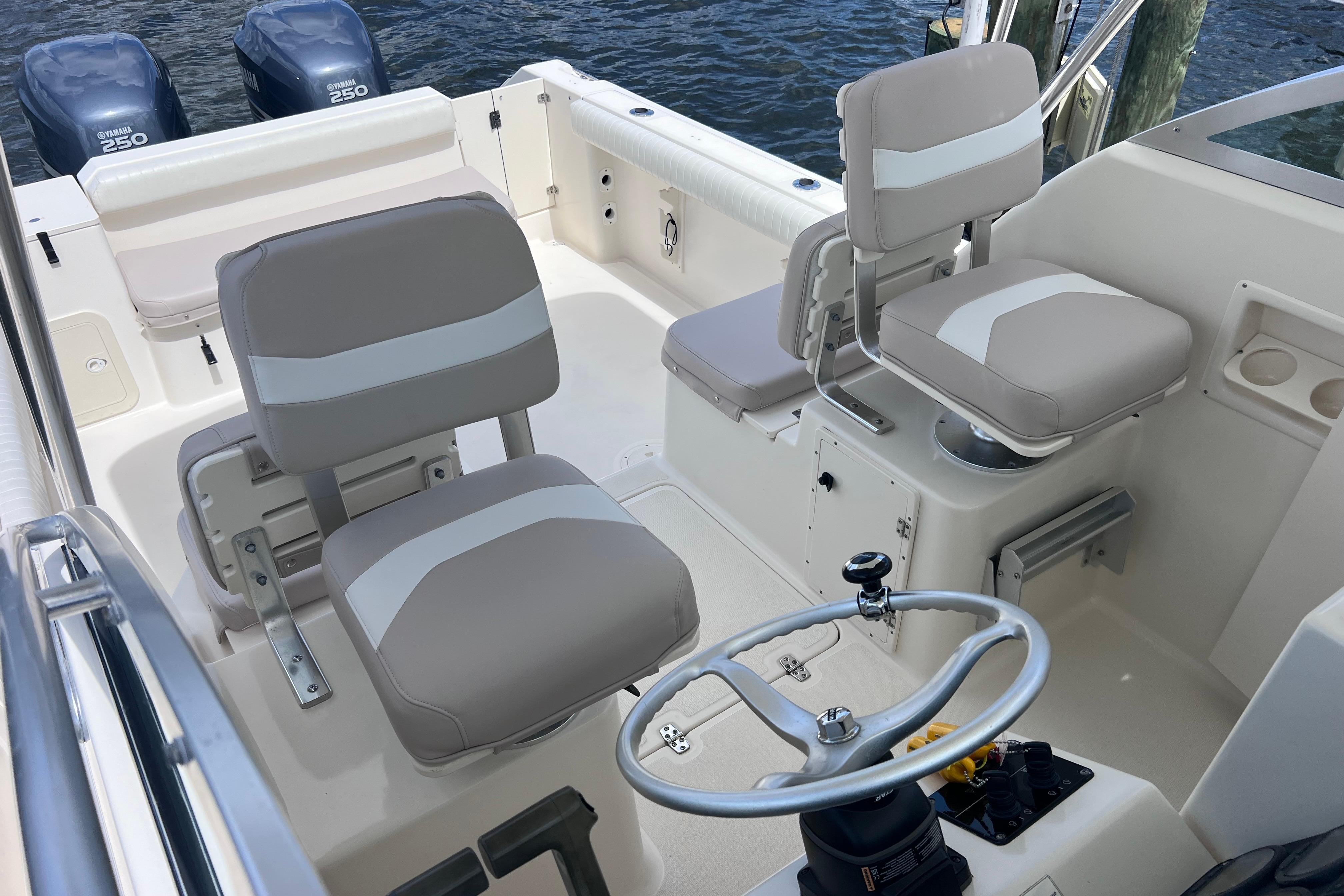 2004 Pursuit 2870 Walkaround boat interior with dual seats and steering wheel.
