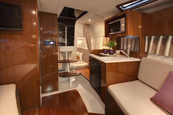Manufacturer Provided Image: 2017 Four Winns Vista 275 interior with kitchenette, seating, and dining area.
