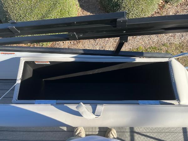Open storage compartment on a 2024 Starcraft SLS3 boat.