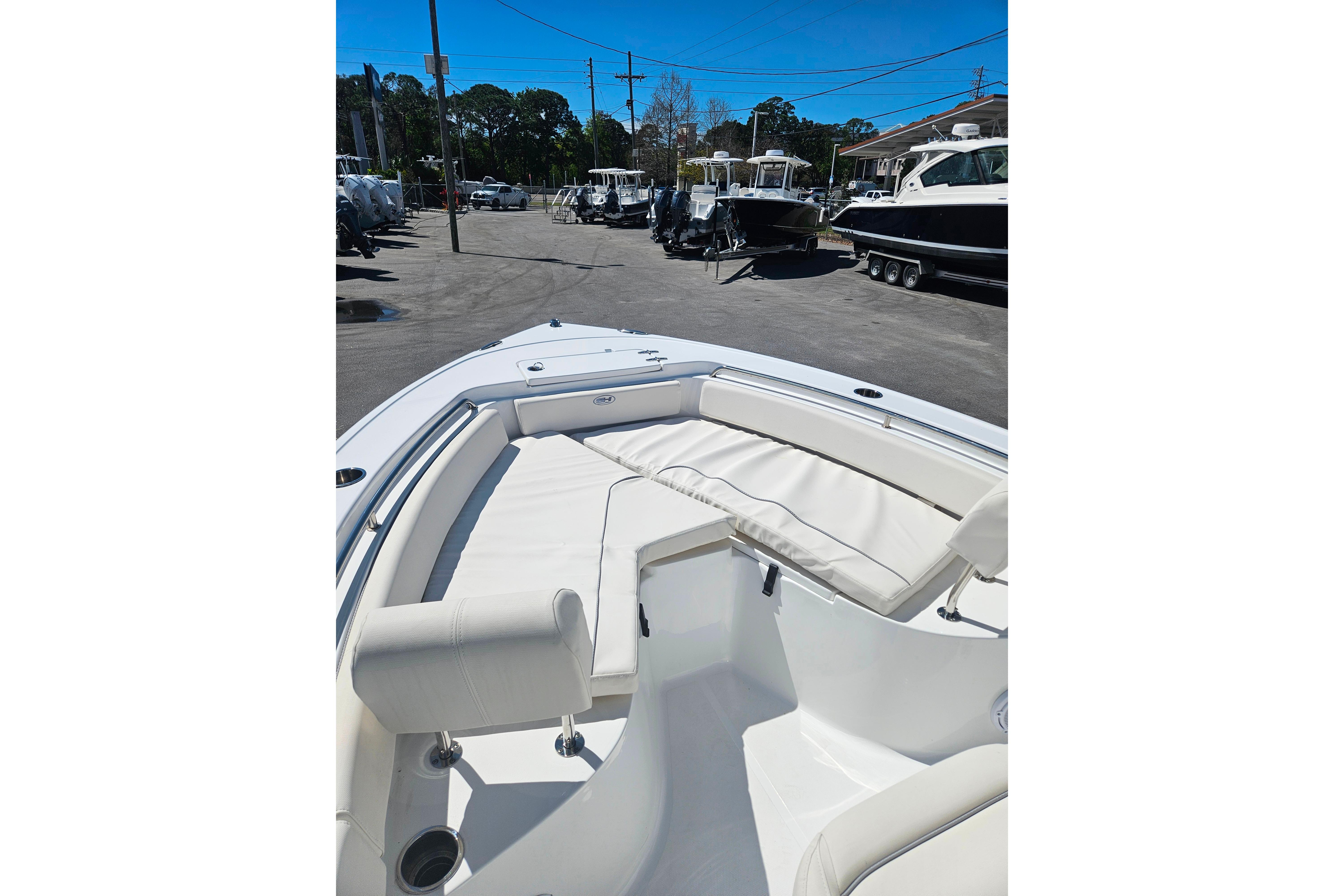 2023 Sea Hunt Ultra 229 boat with spacious seating in a marina setting.