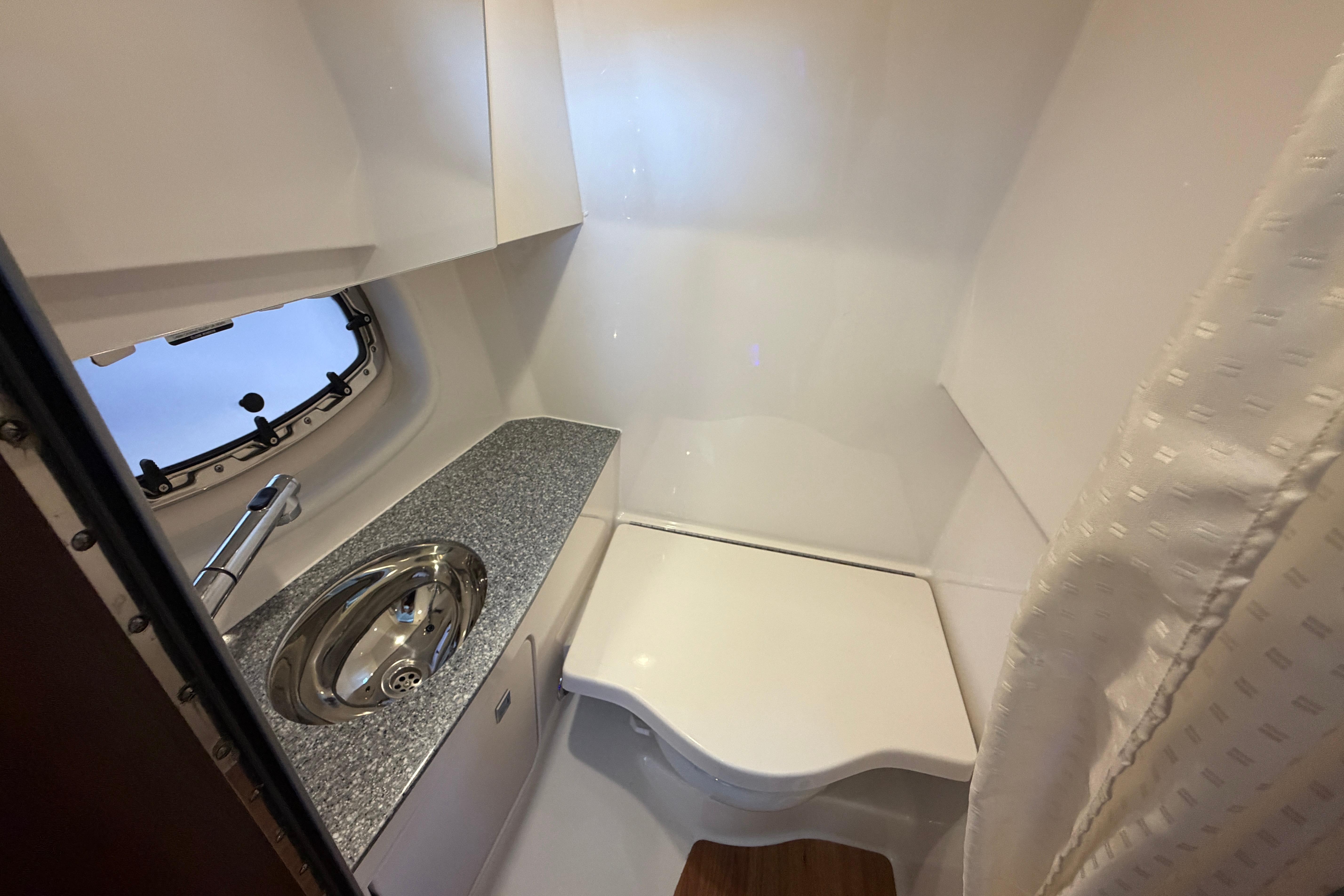 2018 Chaparral 347 SSX boat bathroom with sink and compact design.